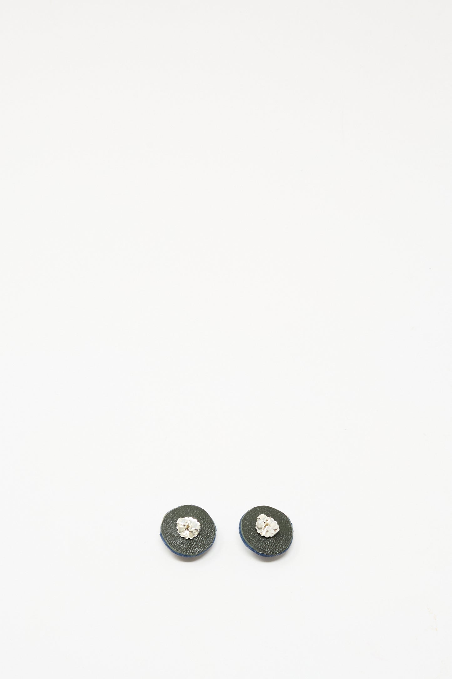 Robin Mollicone's Stud Earrings in Sodalite are round, black gemstone studs featuring a central silver or clear gem, set in sterling silver findings and shown on a plain white background.
