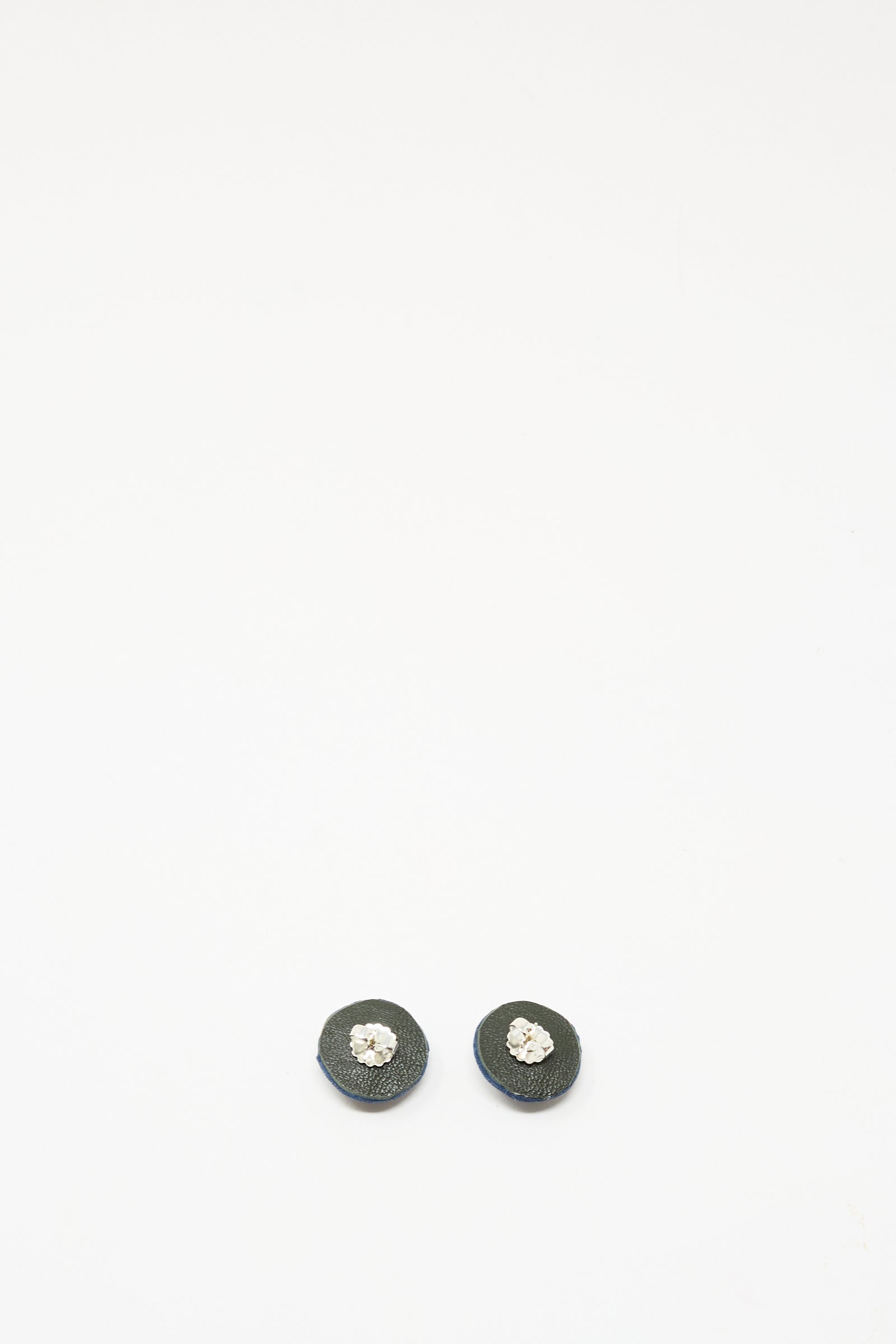 Robin Mollicone's Stud Earrings in Sodalite are round, black gemstone studs featuring a central silver or clear gem, set in sterling silver findings and shown on a plain white background.
