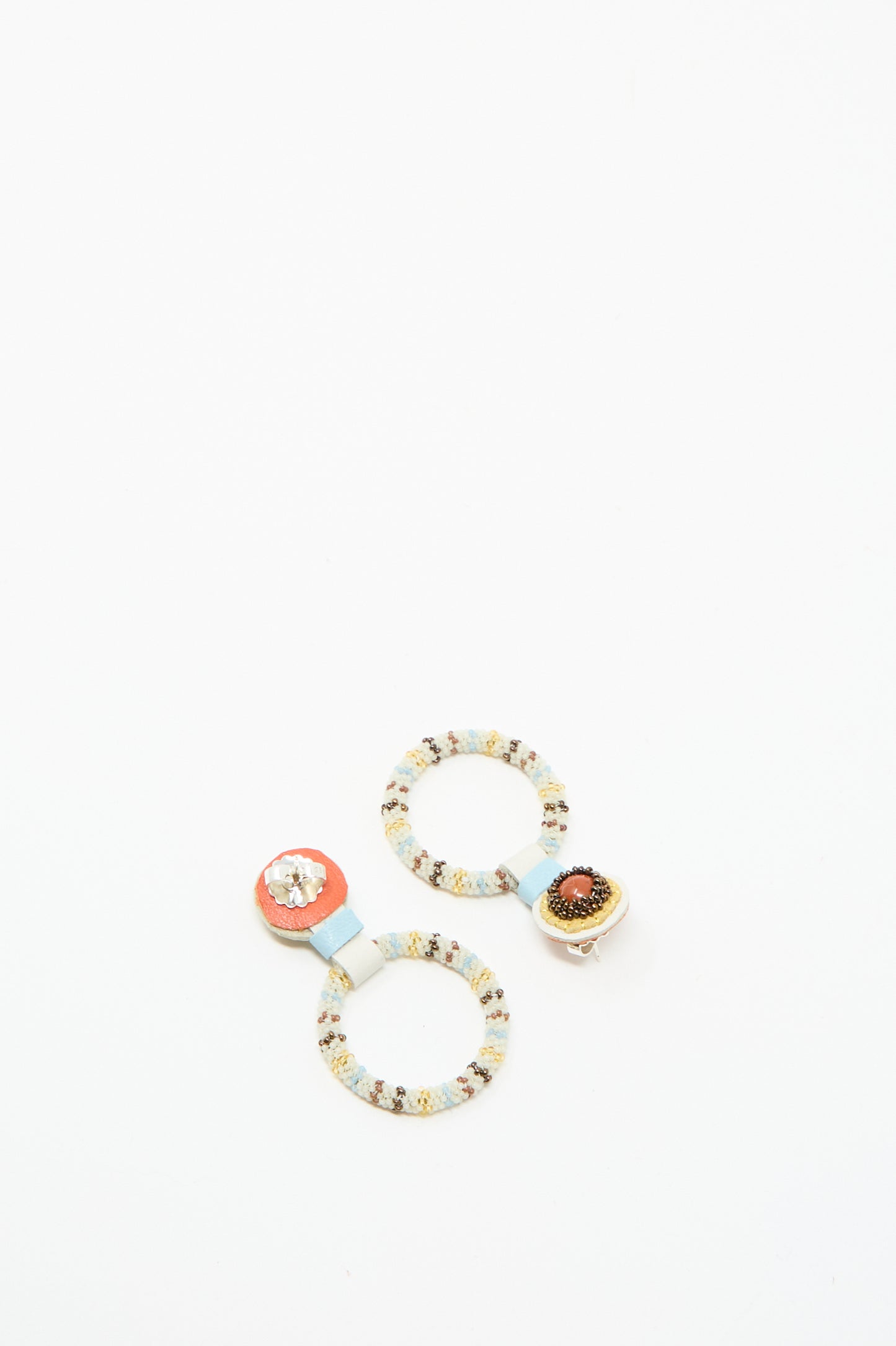 Handcrafted in NYC by Robin Mollicone, these Small Beaded Hoop Earrings in Red Jasper feature two hoops joined by blue bands, each with a unique beaded center.
