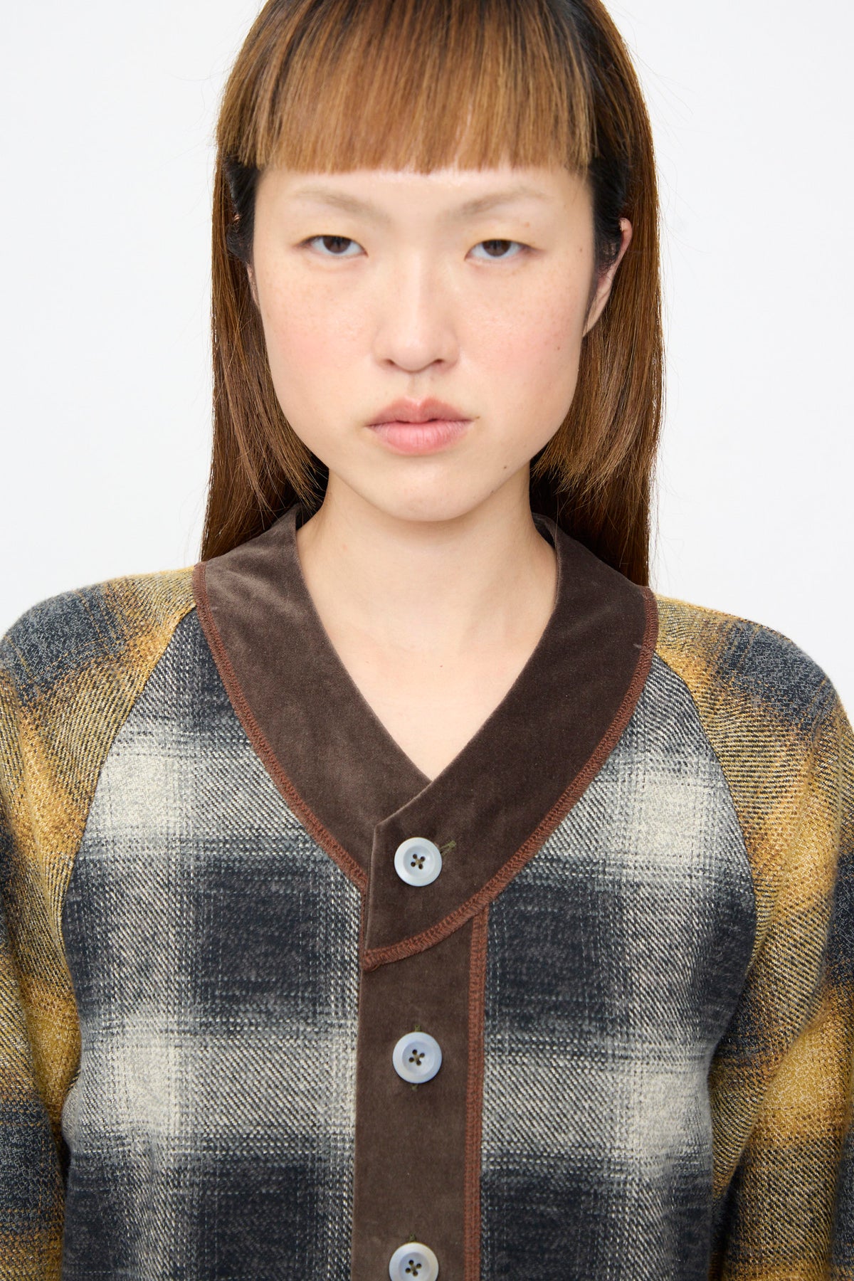 A Cotton Flannel Frame Dress in Scholar, a long-sleeved midi dress featuring a brown velvet V-neck collar and a button-down front.