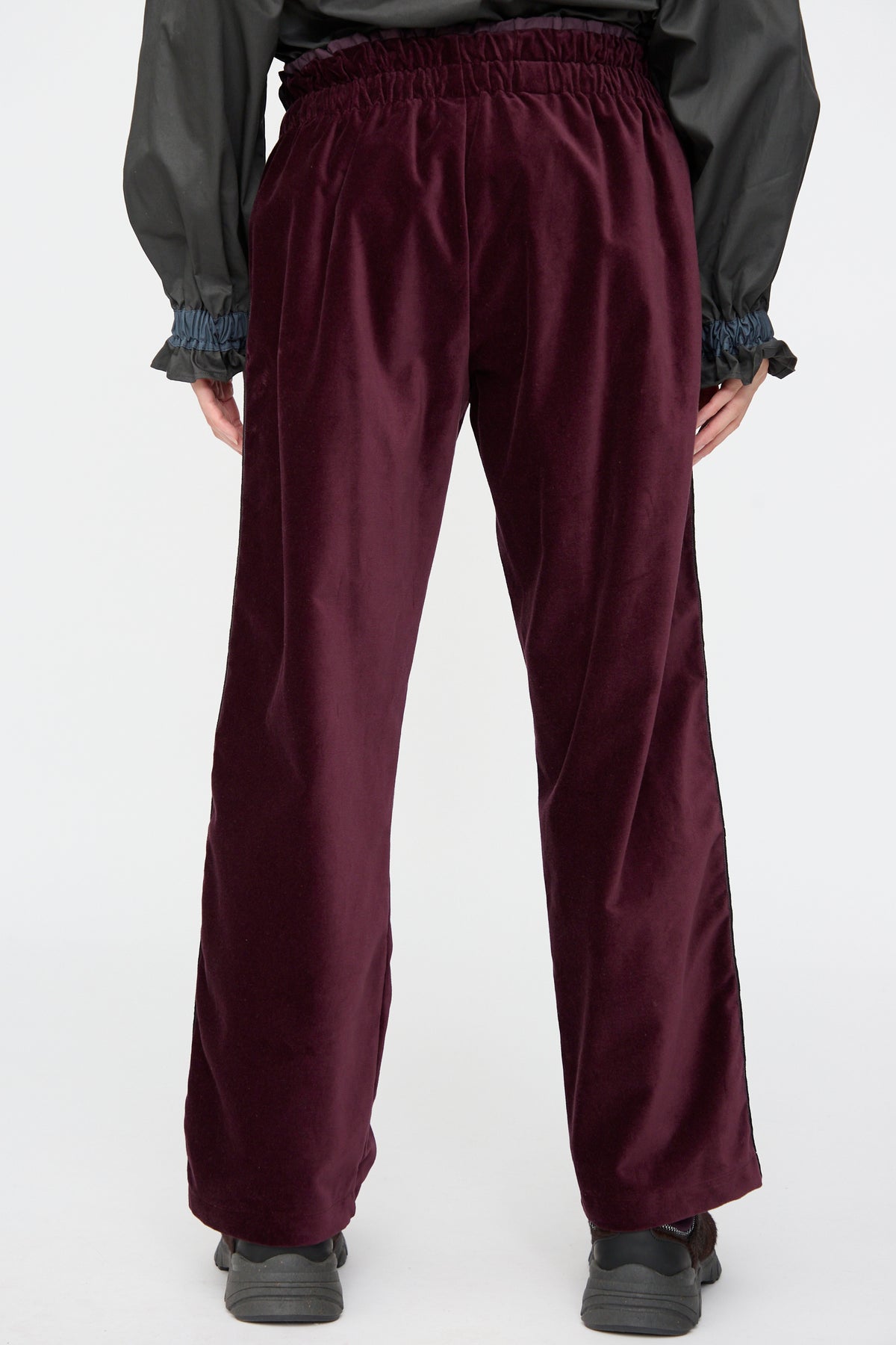 Back view of dark purple Cotton Velvet Chord Pants in Noble, featuring a straight leg and an elastic waistband.