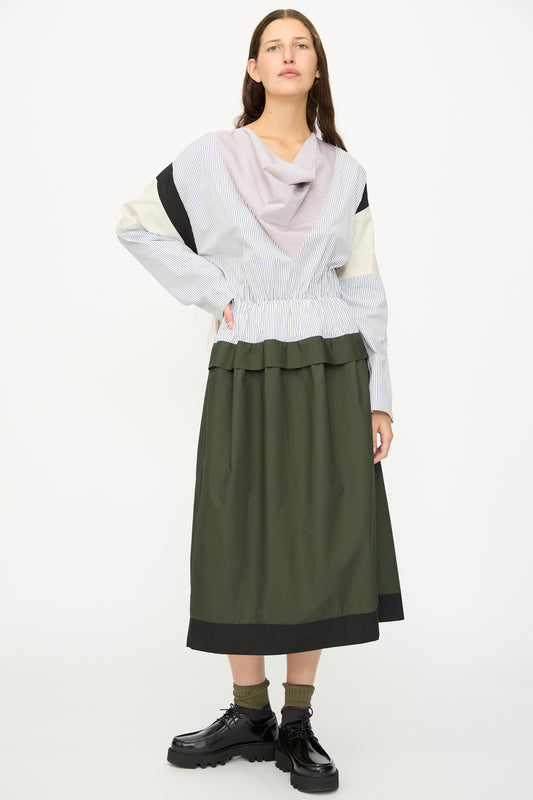 A woman in the SC103 Poplin Mix Solace Dress in Horizon.