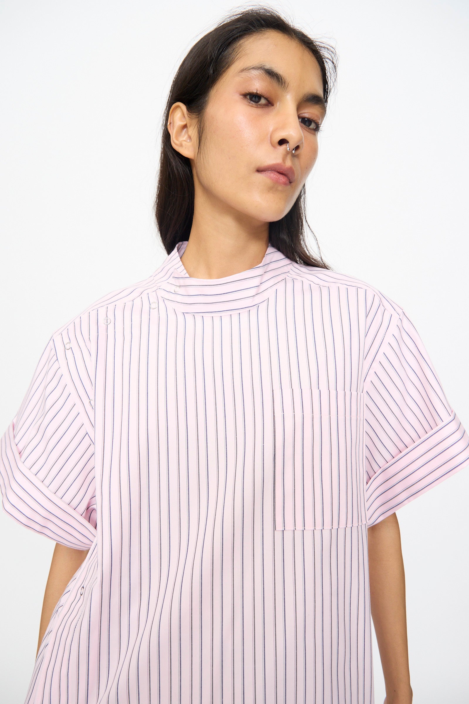 Model wears the SC103 Stripe Cotton Wish Top in Blushline, featuring light pink cotton fabric with thin vertical black stripes and short sleeves, posed against a plain white background.