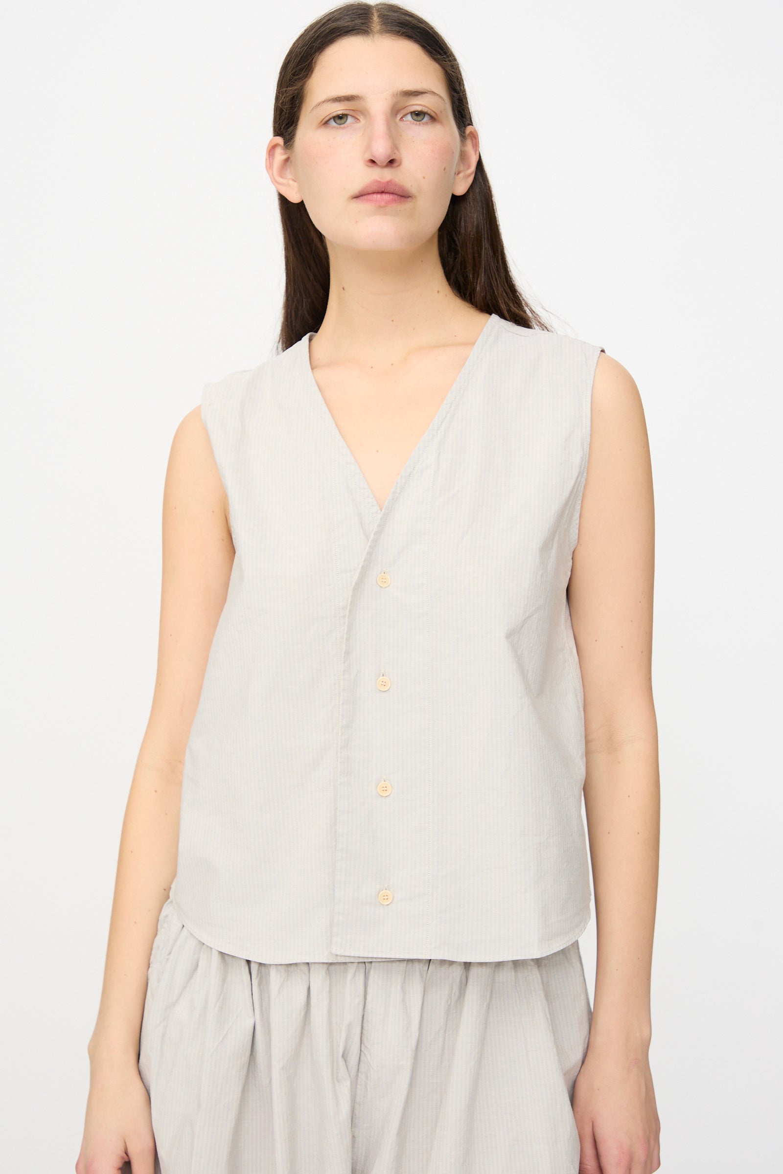 A person wears the SONO Victor Vest in Dusty Stripe Fine, standing against a plain background and facing the camera.