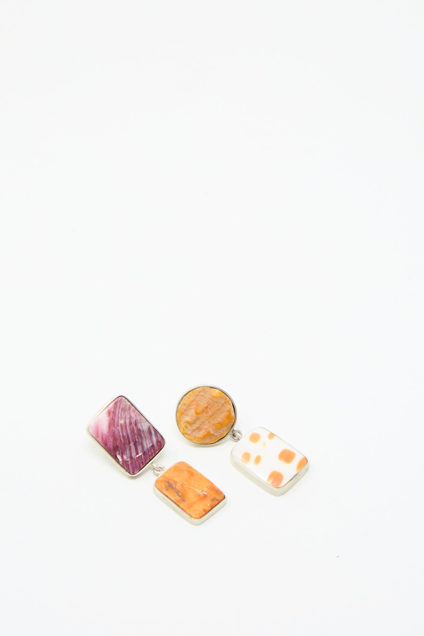 Arranged on a plain white background the La Ma r Sterling Silver No. 09 Earrings in Pink and Orange Shell collection. 