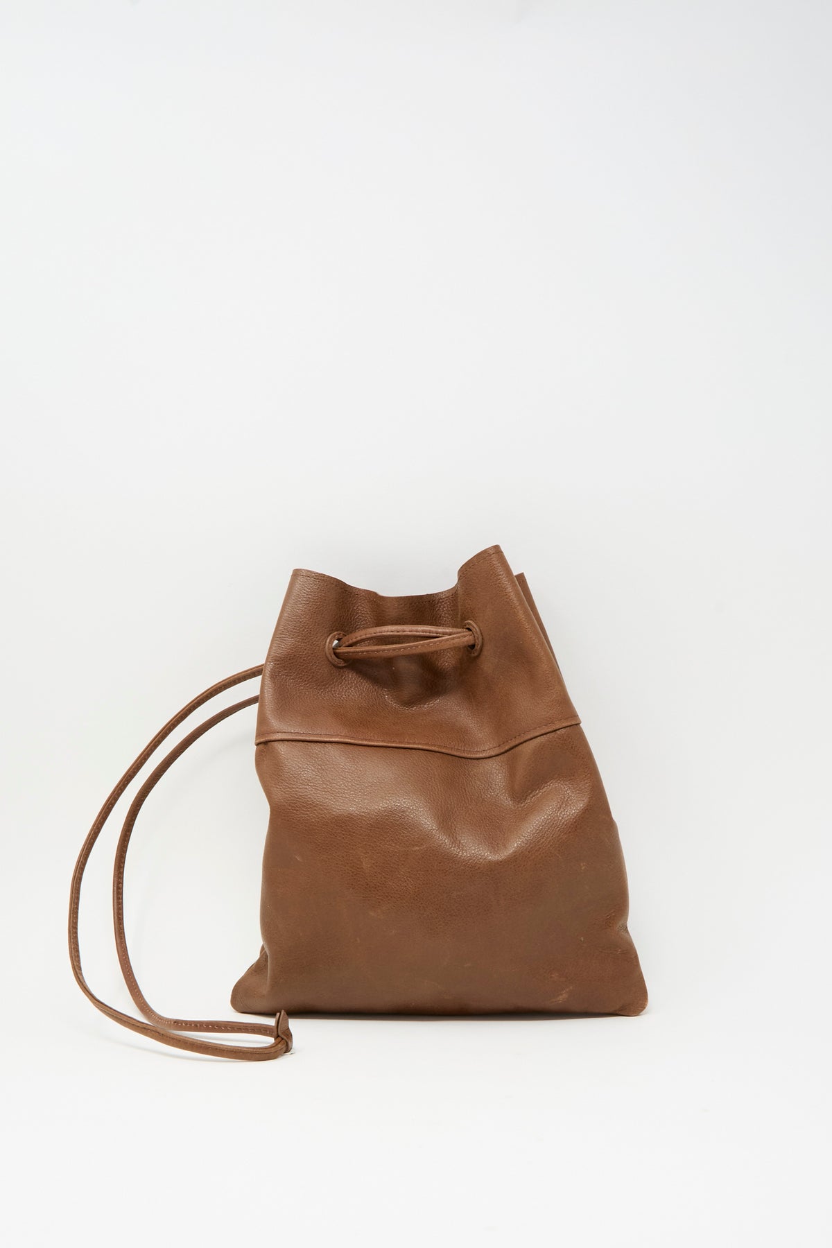 Brown Sabina Leather Hansi Bag in a drawstring style with a long shoulder strap.
