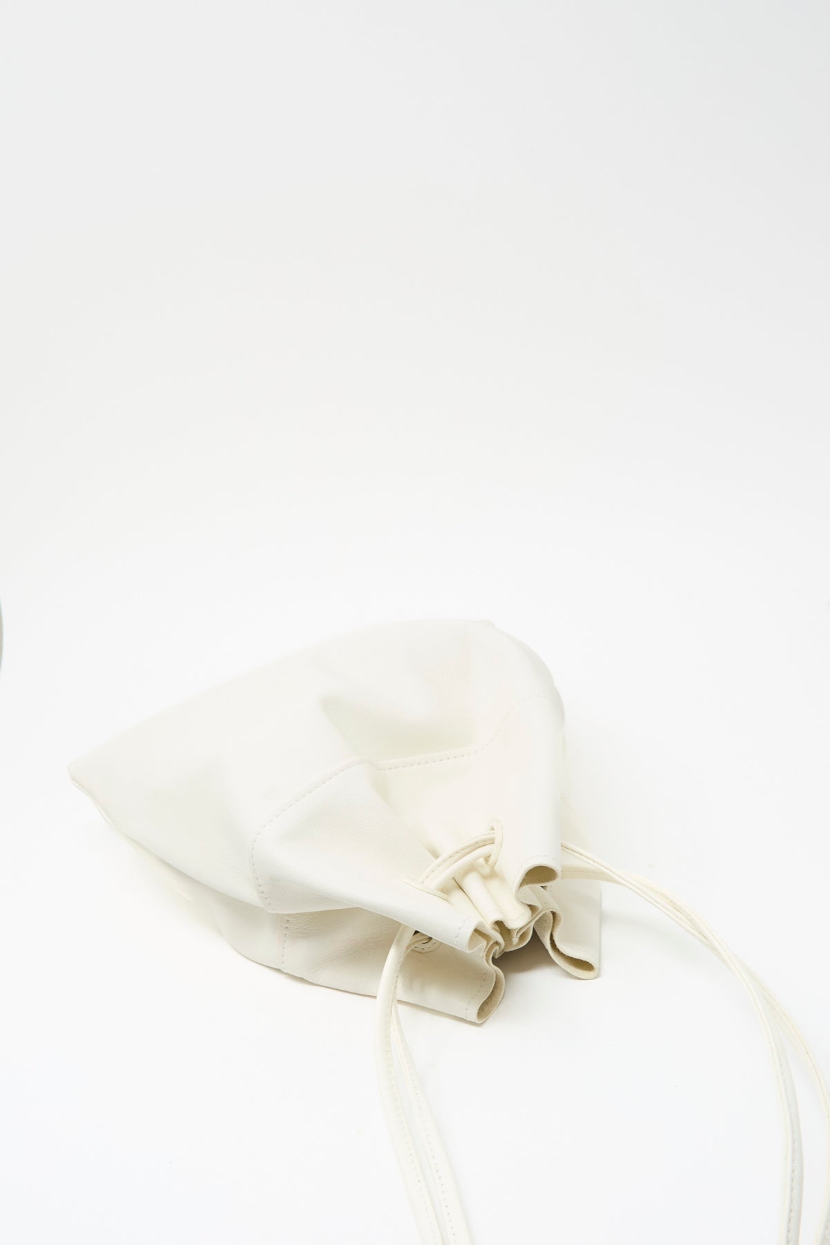 Sabina Leather The Hansi Bag in white with a drawstring closure and thin shoulder strap.