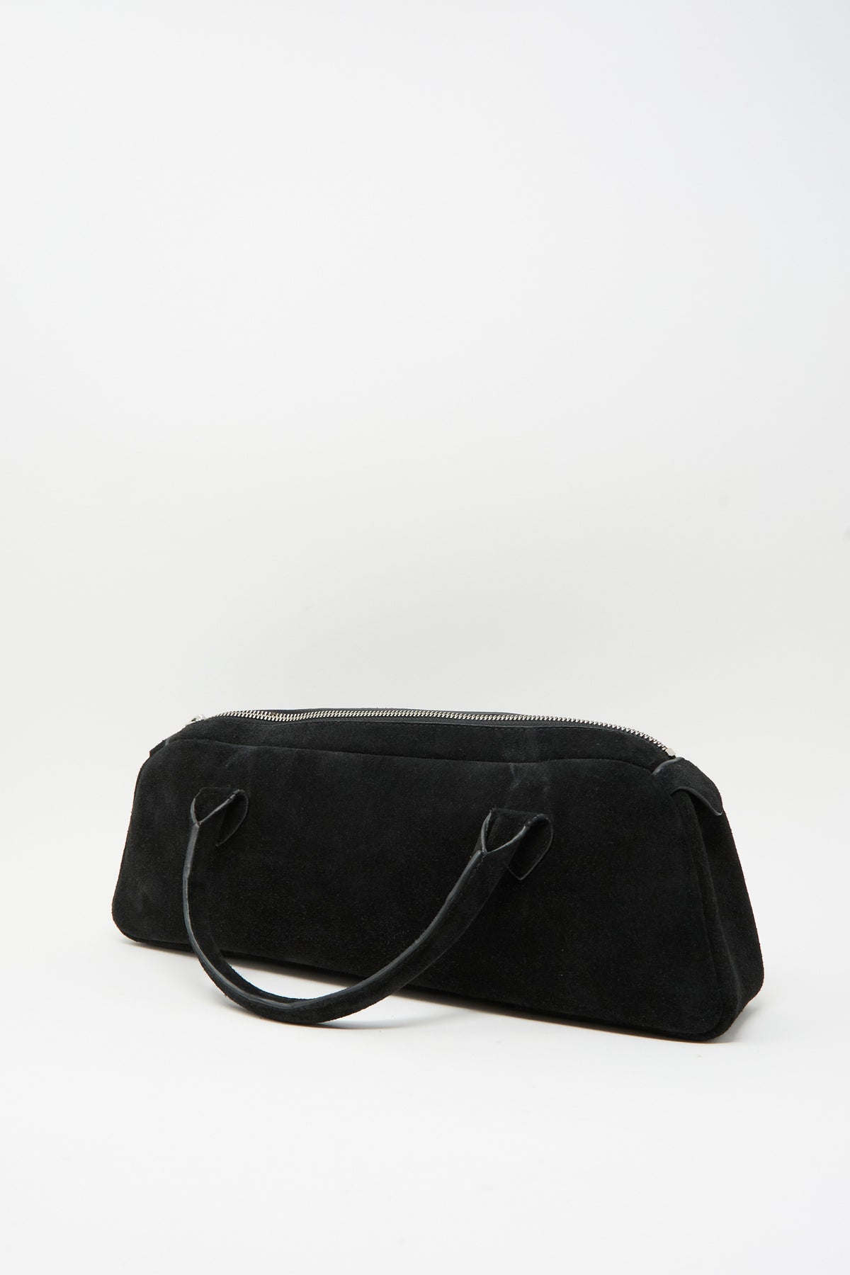 Sabina Suede The Bottle Bag in black, a small cylindrical handbag with a top zipper and two handles.