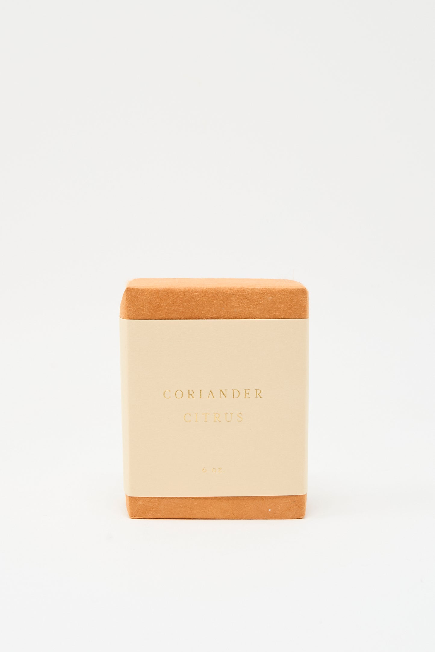 A handcrafted SAIPUA Olive Oil Bar Soap in Coriander Citrus, with a tan label reading "Coriander Citrus 6 oz.," stands upright against a white background. Made in New York, it features a refreshing blend of essential oils.