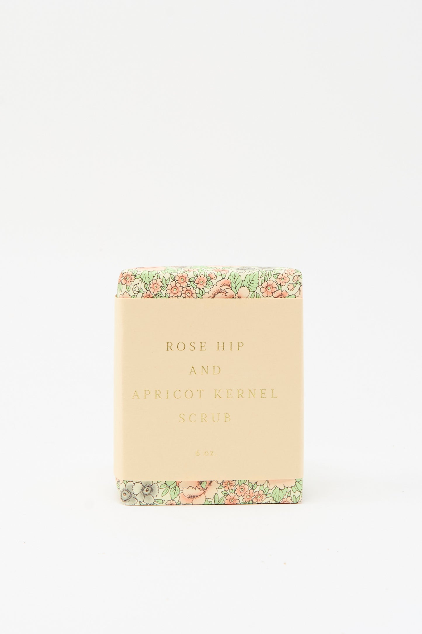 The SAIPUA Rose Hip and Apricot Kernel Scrub Soap, featuring floral packaging, stands against a plain white background, highlighting the appeal of handcrafted soaps.