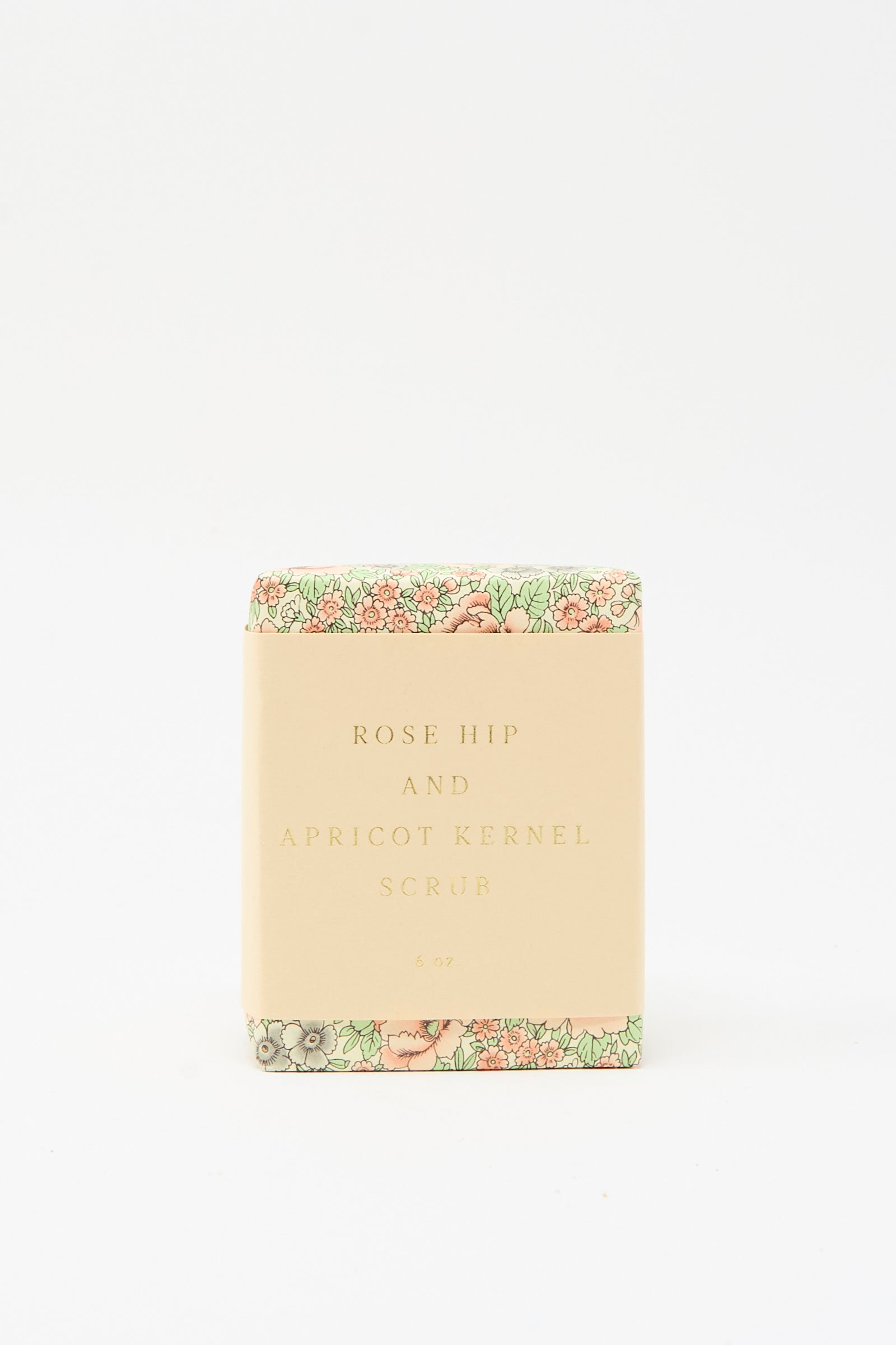 The SAIPUA Rose Hip and Apricot Kernel Scrub Soap, featuring floral packaging, stands against a plain white background, highlighting the appeal of handcrafted soaps.
