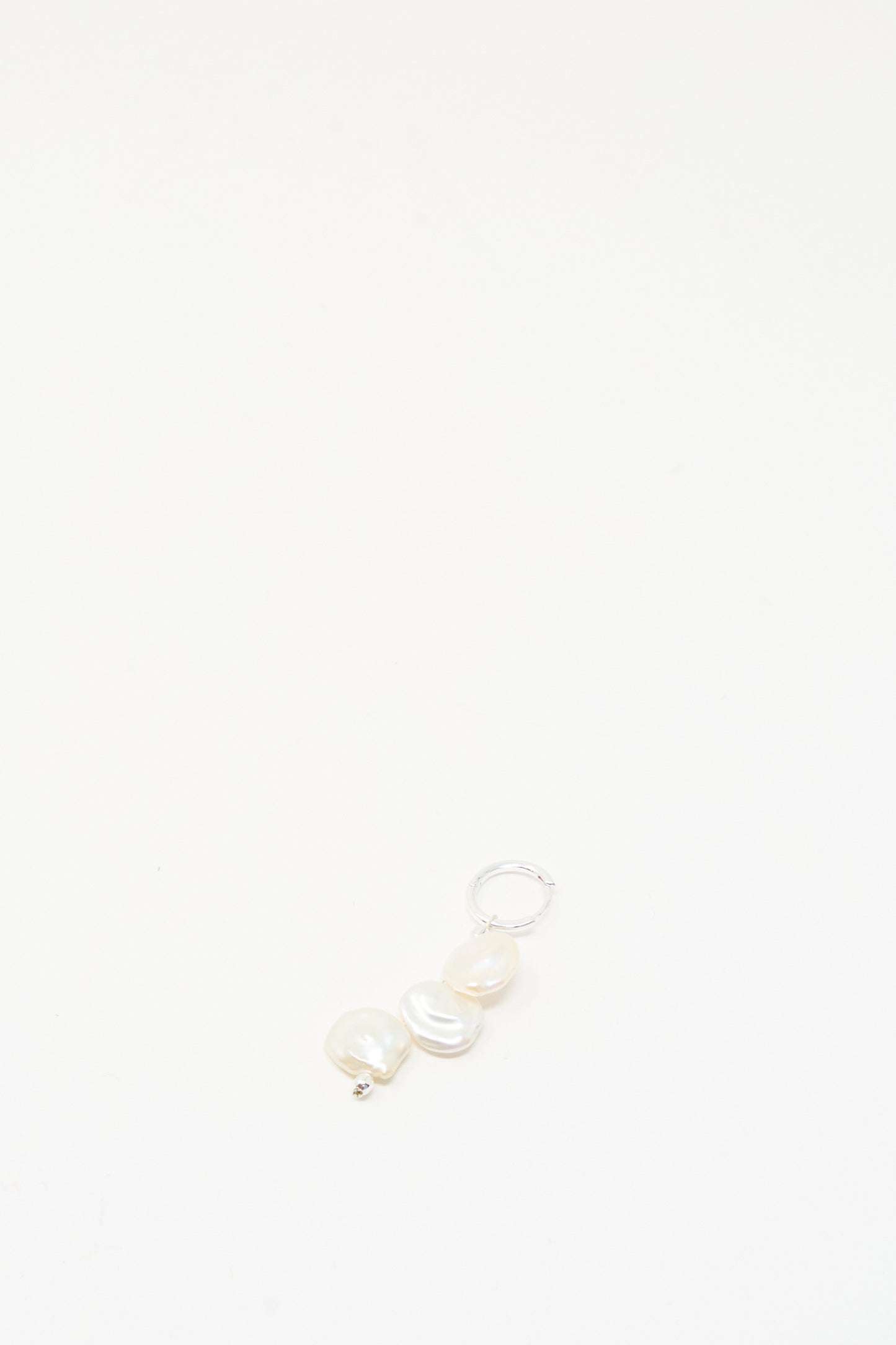 The Baba Single Earring in Triple Baby by Santangelo features three irregular keshi pearls and a silver loop, handmade in NYC, shown centered on a plain white background.