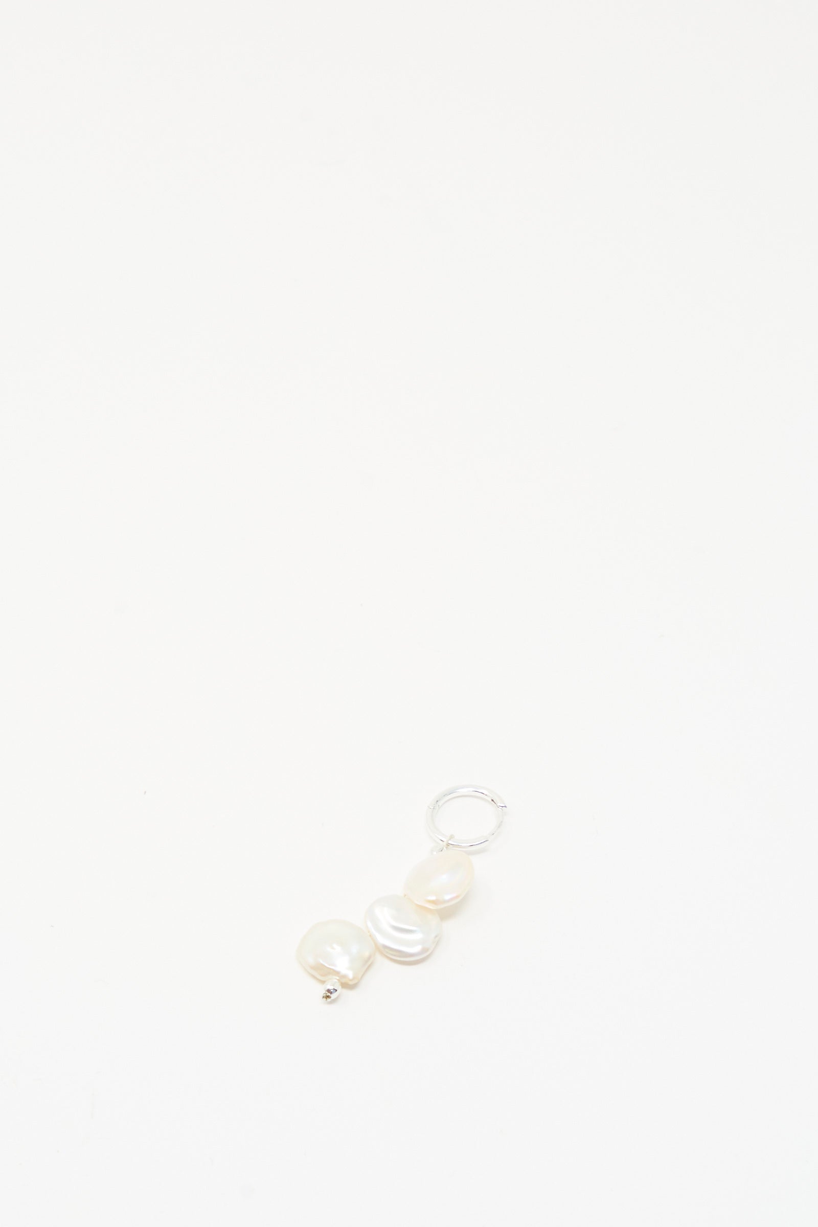 The Baba Single Earring in Triple Baby by Santangelo features three irregular keshi pearls and a silver loop, handmade in NYC, shown centered on a plain white background.