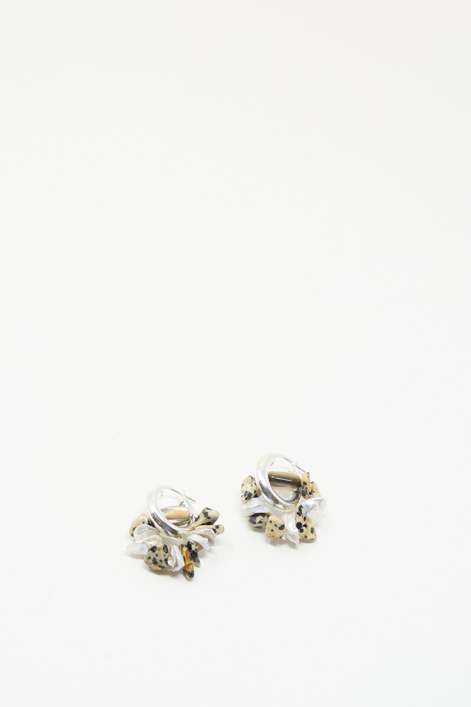 The Che Bomba Earrings in Abalone Hoop by Santangelo feature small hoops with white, black, and gold bead clusters—beautifully displayed on a plain white background.