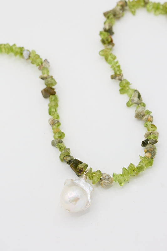 A Santangelo Kitano Necklace in Green with a large cultured fireball pearl pendant on a white background.