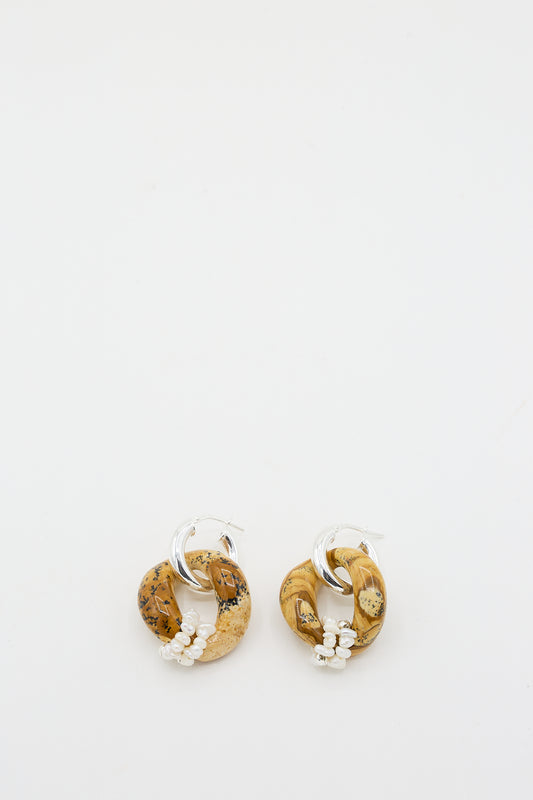 A pair of Santangelo Sand Jasper Bad Orb Earrings with silver hoops and circular wooden pendants on a white background.