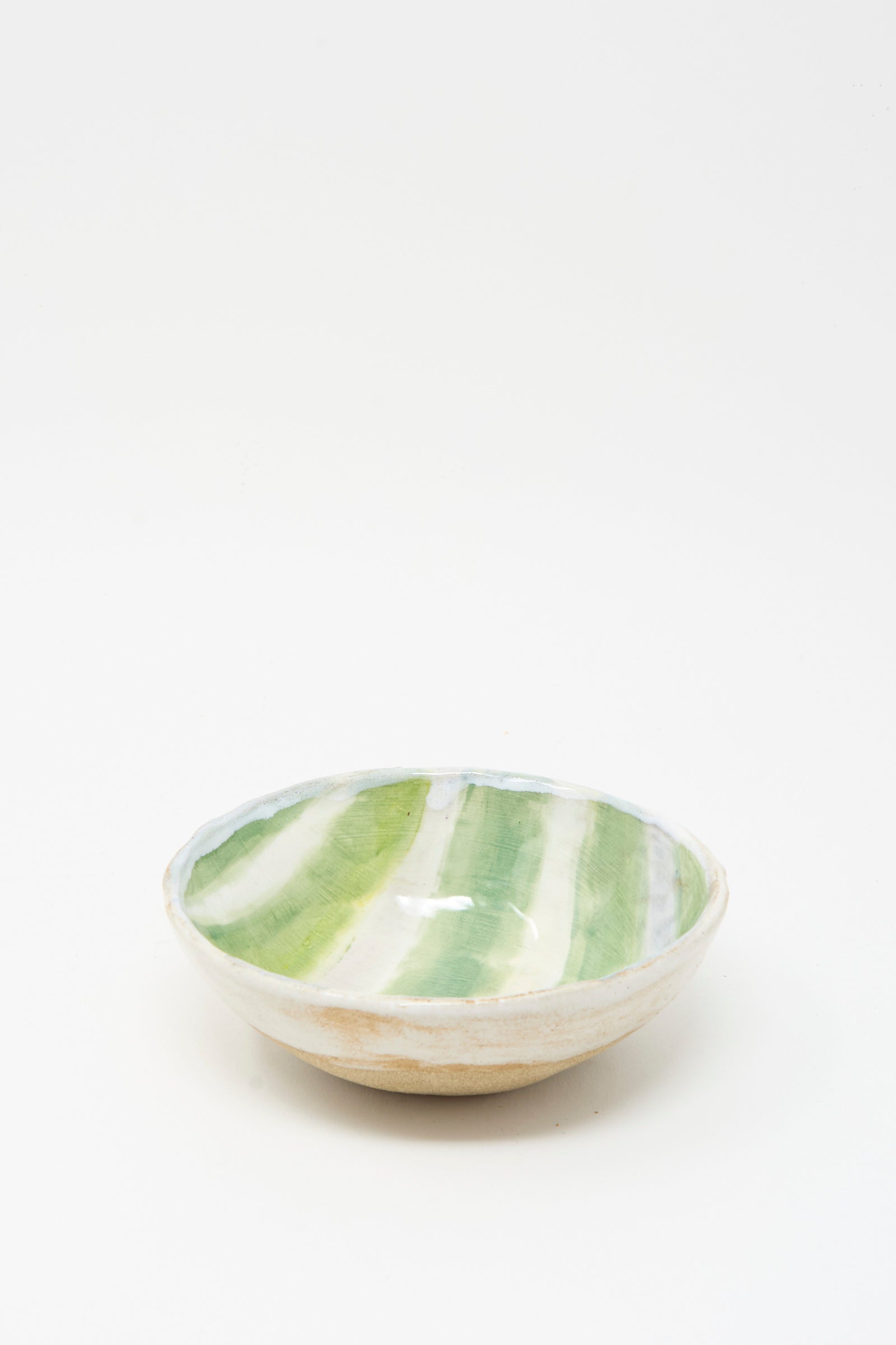 The Bowl in Green and White Stripes by Shino Takeda is a handmade ceramic piece from New York, featuring green and white stripes glazed inside, shown on a plain white background.