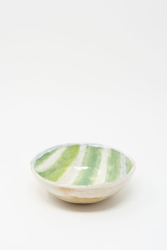 The Bowl in Green and White Stripes by Shino Takeda is a handmade ceramic piece from New York, featuring green and white stripes glazed inside, shown on a plain white background.