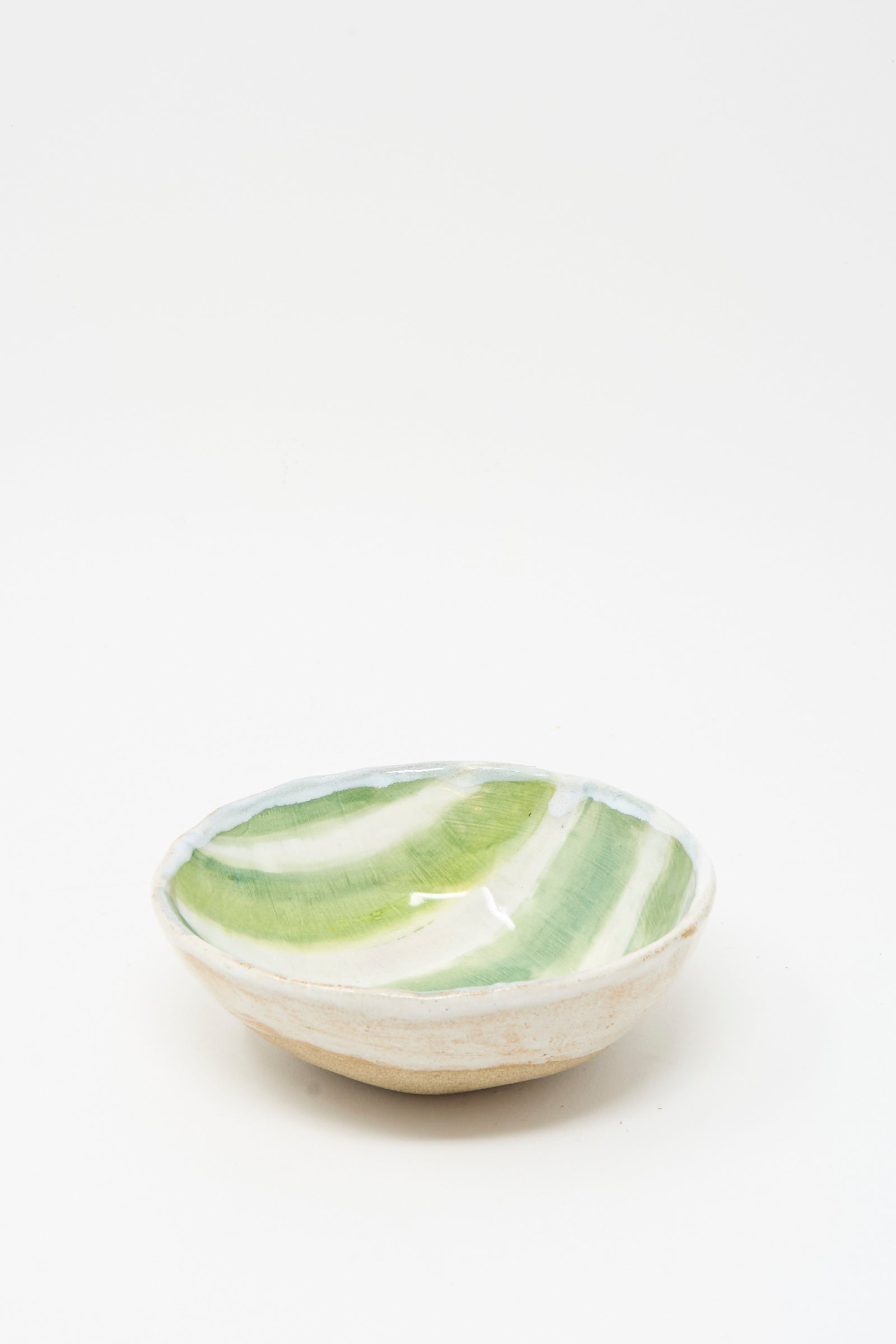The Shino Takeda Bowl in Green and White Stripes is a small, shallow handmade ceramic piece featuring a white exterior and a green-and-white striped interior, shown against a plain white background.