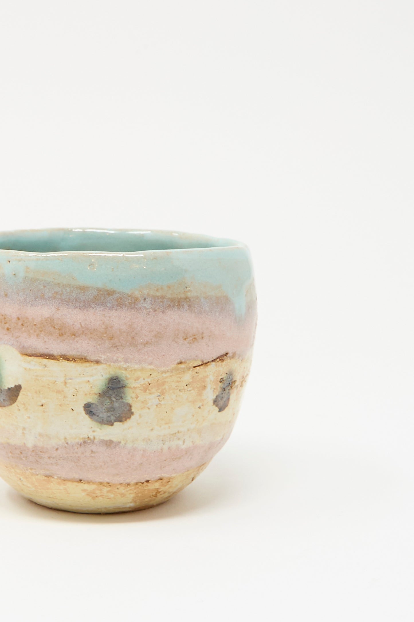 The Shino Takeda Cup in Dots II, a hand-painted ceramic cup with pastel blue and pink glaze, made in New York, is displayed on a white background.