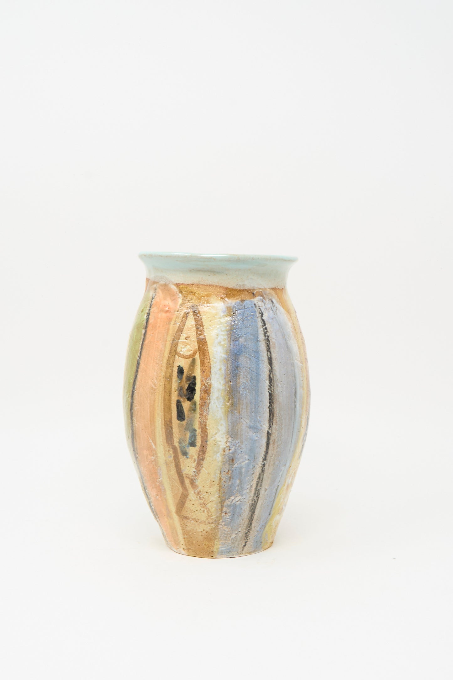 The Fish Vase in Multi Stripe by Shino Takeda is a tall handmade clay vase with a light blue rim and vertical pastel peach, yellow, and blue stripes on white—a colorful piece perfect for brightening any space.
