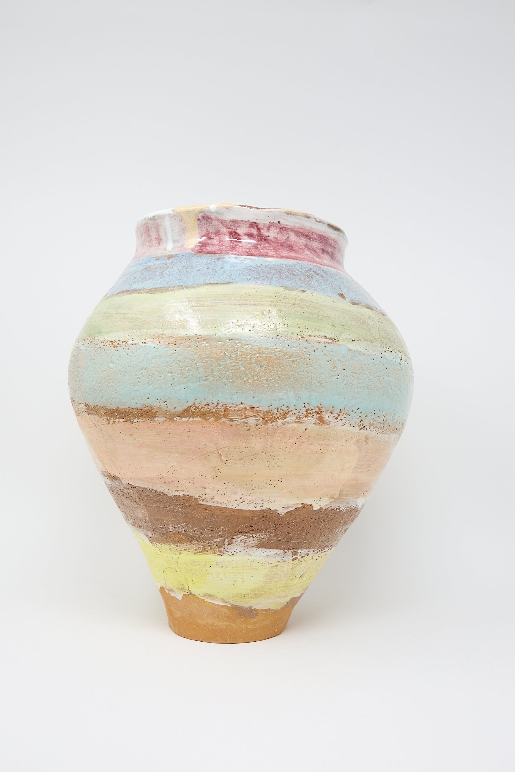 A large vase by Shino Takeda, featuring a round shape with hand-painted pastel stripes in pink, yellow, blue, and green on a white clay background.