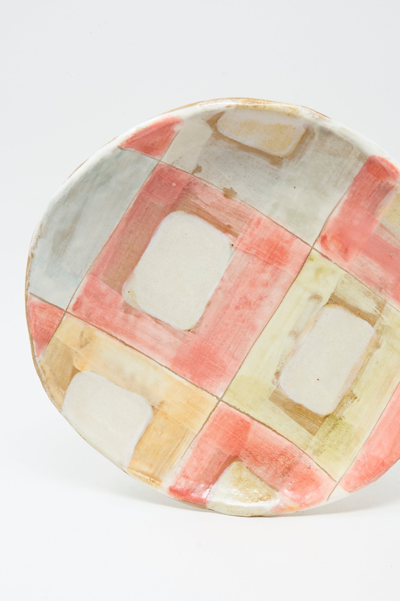 The Serving Shallow Plate in Squares by Shino Takeda is a handmade ceramic piece with New York charm, featuring a colorful check wash in muted red, yellow, green, and beige on a white background.