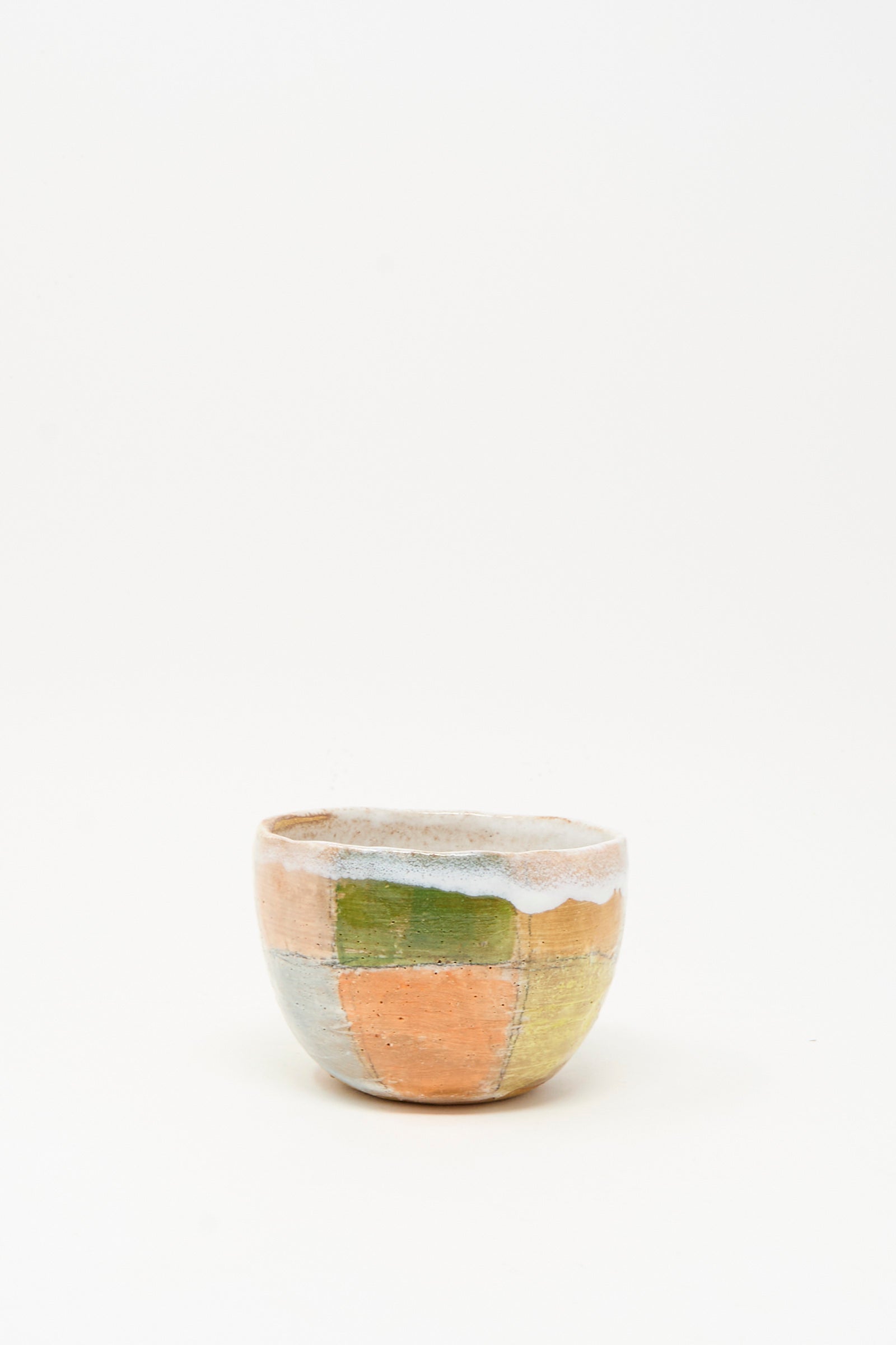 The Small Bowl in Check Multi II by Shino Takeda is a hand-painted ceramic piece with a patchwork of muted orange, green, and blue, handmade in New York and shown on a plain white background.