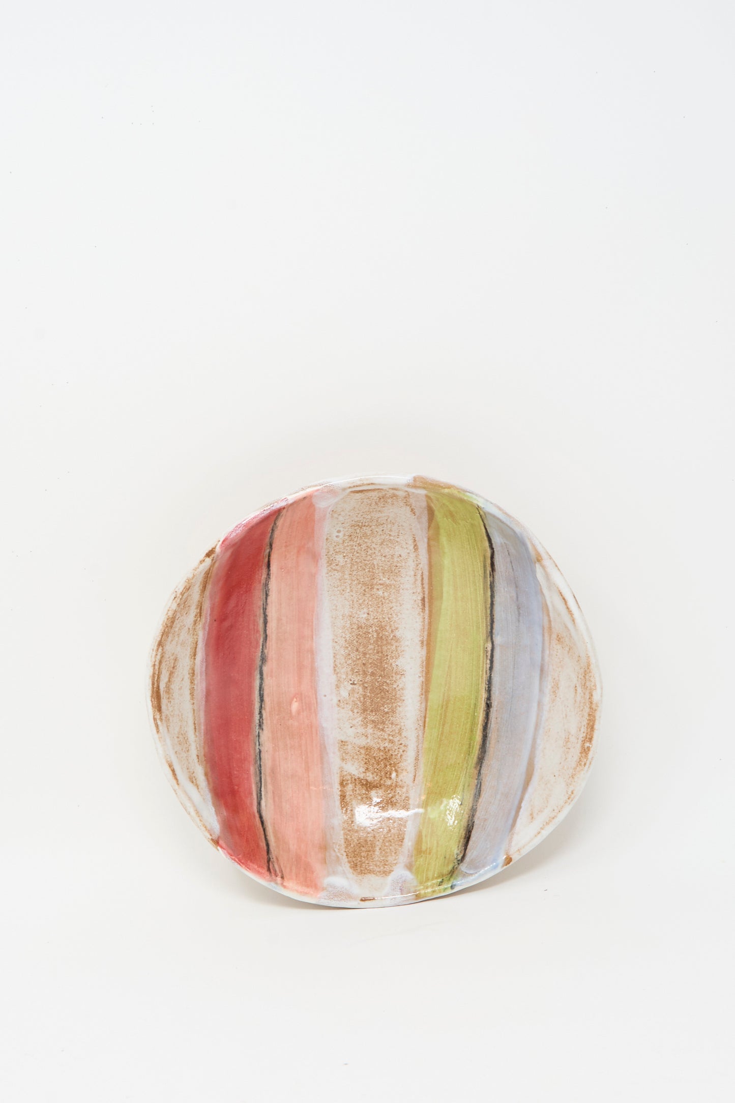 The Stripe Serving Bowl in Multi I by Shino Takeda is a round ceramic bowl with vertical red, brown, green, and light blue brushstroke stripes on white glaze. Expertly crafted in New York.