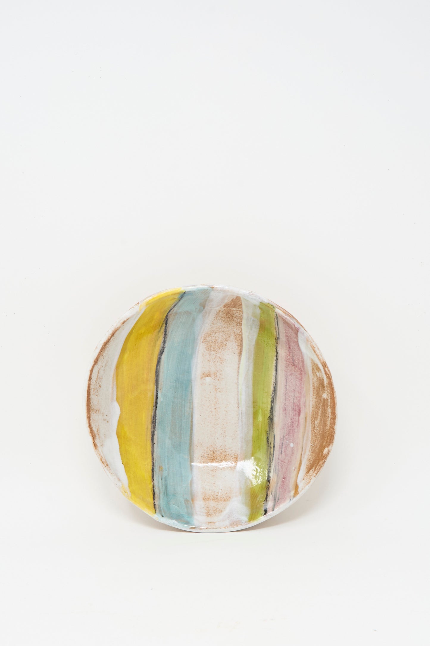 The Stripe Serving Bowl in Multi II by Shino Takeda features a round ceramic design with pastel yellow, blue, pink, brown, and white stripes—perfect for serving snacks and elevating any table setting.