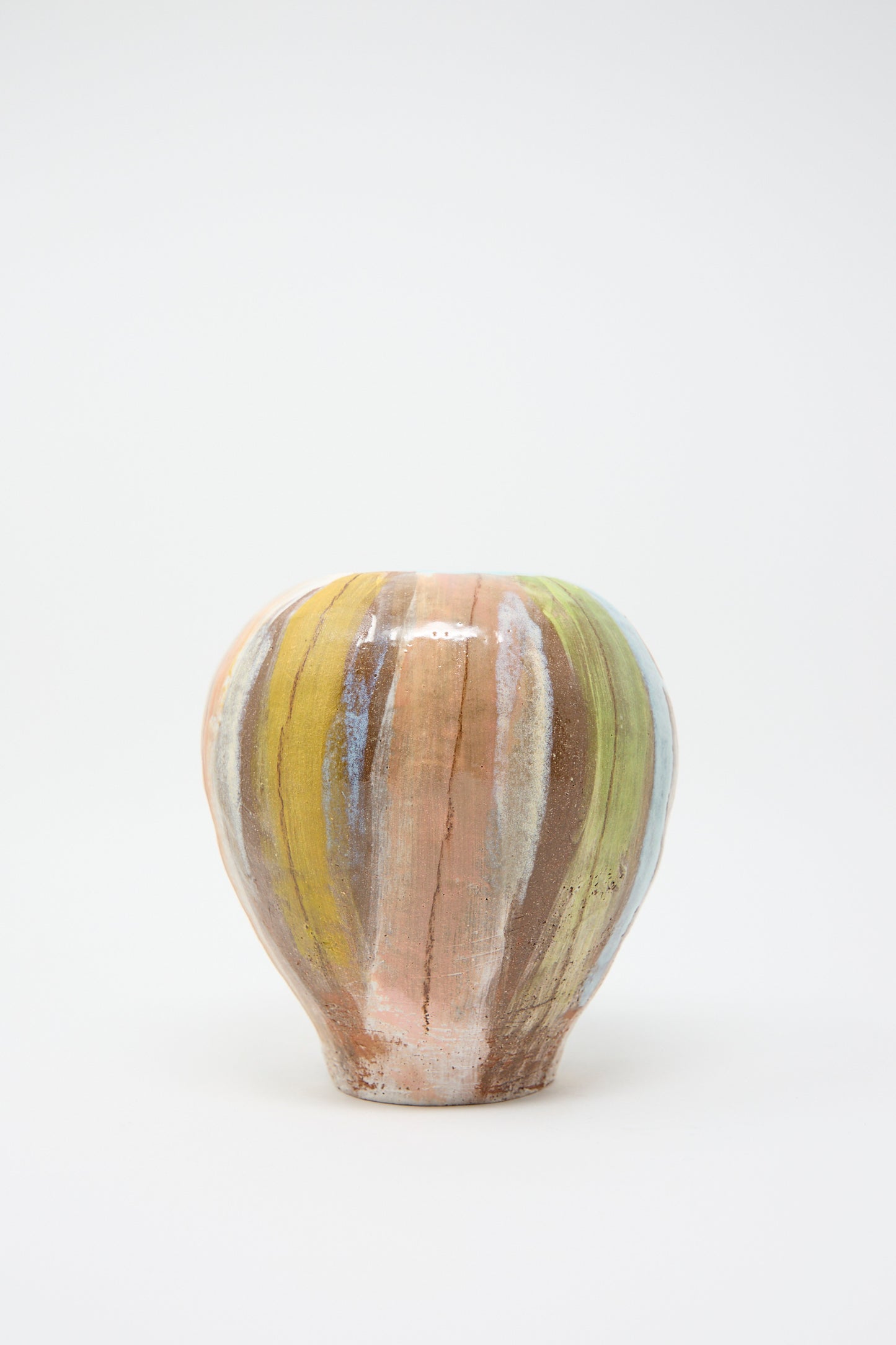 The "Vase in Pastel Stripe" by Shino Takeda is a hand-painted ceramic piece featuring multicolored vertical stripes against a white background.