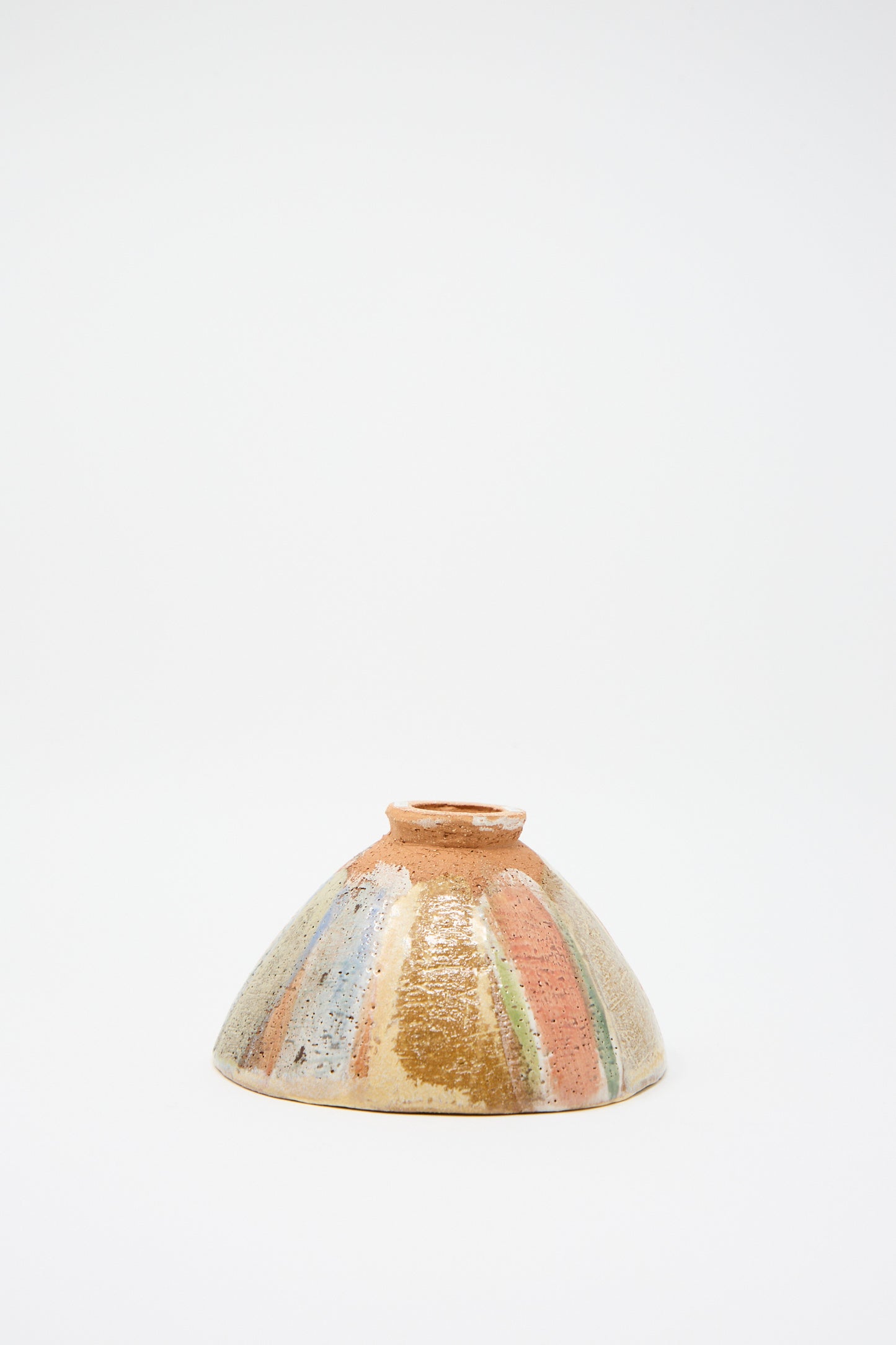 The "Footed Bowl in Pastel Stripe" by Shino Takeda, a small colorful ceramic bowl featuring a hand-painted textured surface with a striped pattern, is displayed upside down against a plain white background.