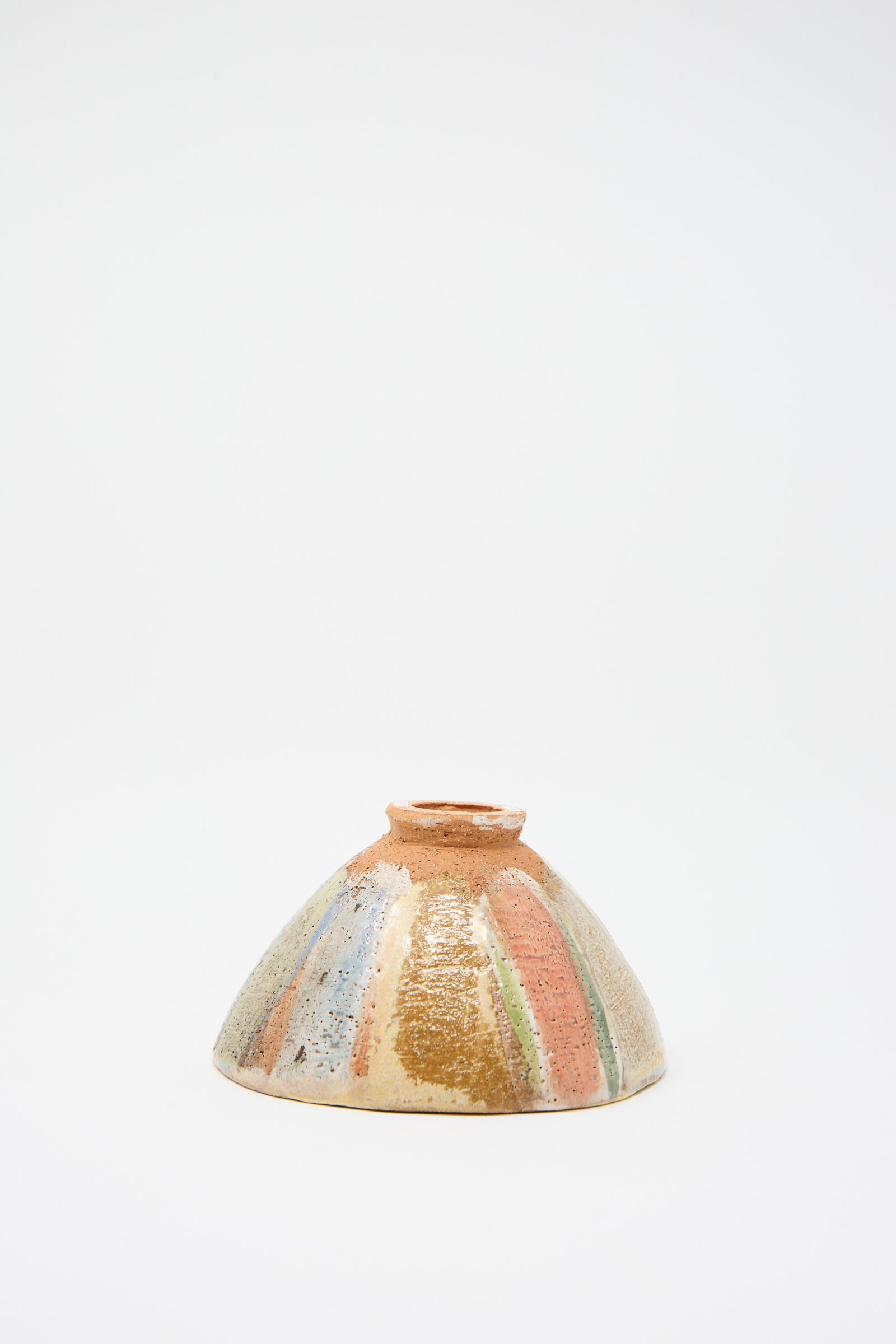 The "Footed Bowl in Pastel Stripe" by Shino Takeda, a small colorful ceramic bowl featuring a hand-painted textured surface with a striped pattern, is displayed upside down against a plain white background.