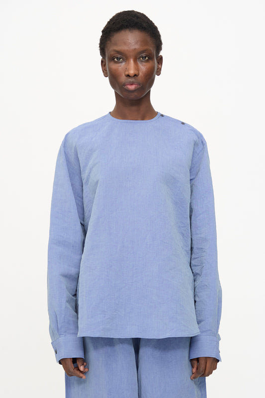 A person stands against a plain white background wearing the Sofie D'Hoore Barel Crewneck in Blue Jeans, paired with matching pants, looking directly at the camera with a neutral expression.