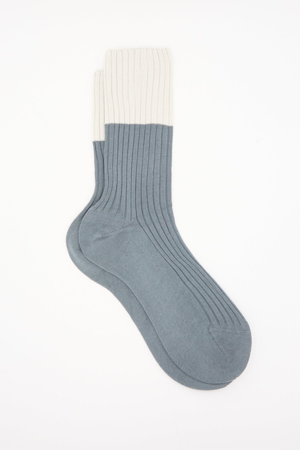 Sofie D’Hoore Bi-Colored Four Rib Socks in Metal, ribbed mid-calf socks with a grey body and cream-colored cuff, made in Italy.