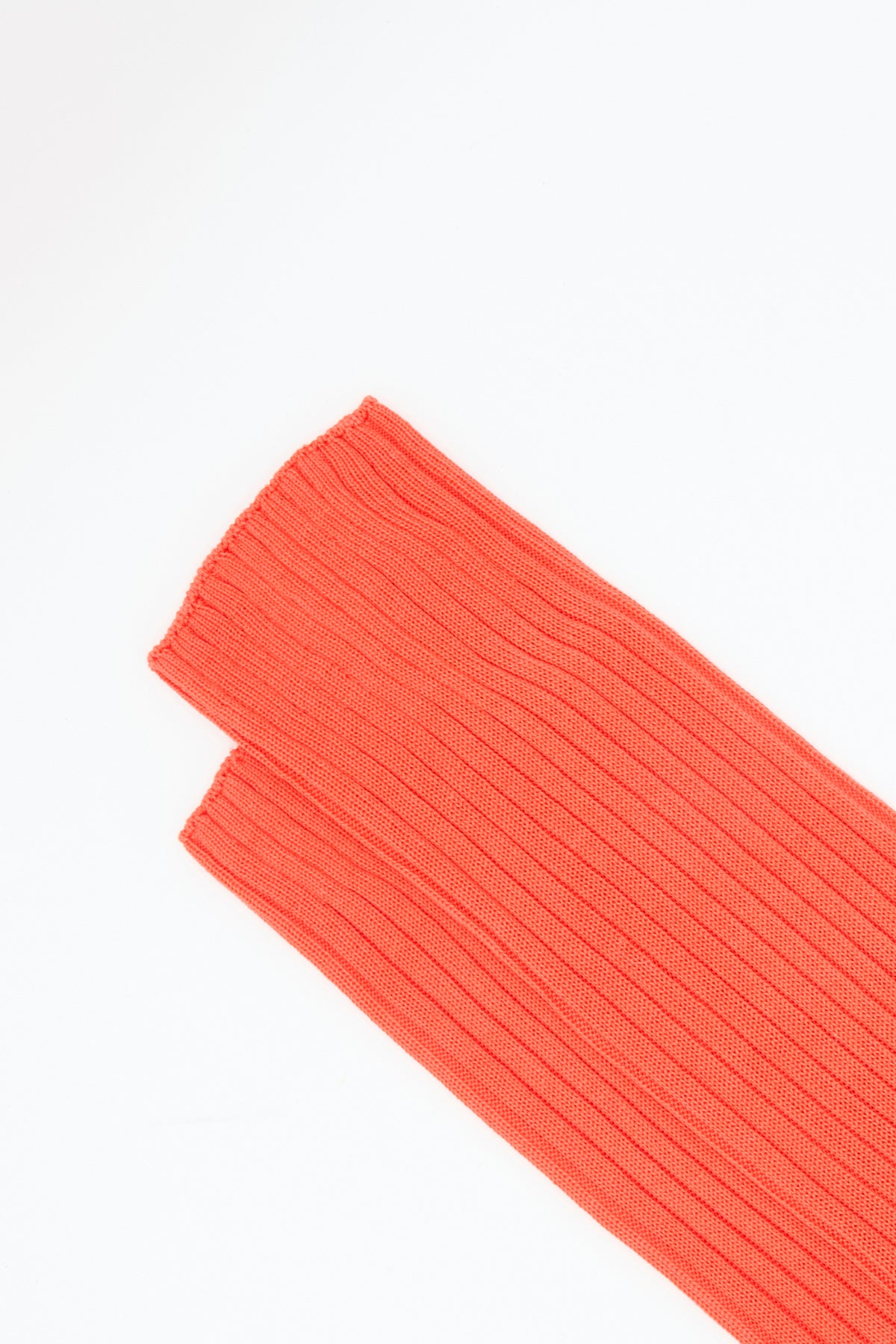 A ribbed, coral-colored cuff of a knee-high Bi-Colored Friday Socks in Camel against a white background.