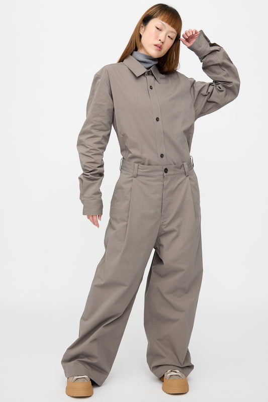A person wearing a grey button-up shirt and a grey turtleneck tucked into matching Compact Winter Cotton Pasadena Pant in Turtle.