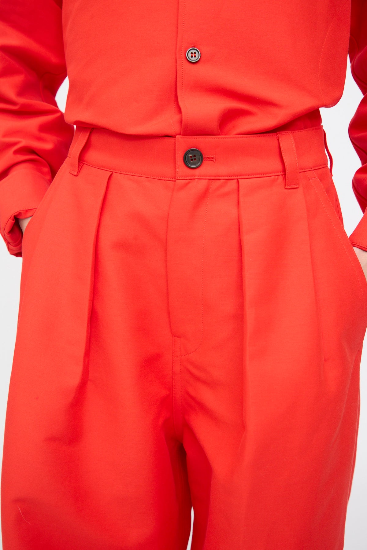 Bright red Cotton Duchesse Piaf Pant in Fire featuring a high-waisted, wide-leg silhouette with front pleats and a button closure.
