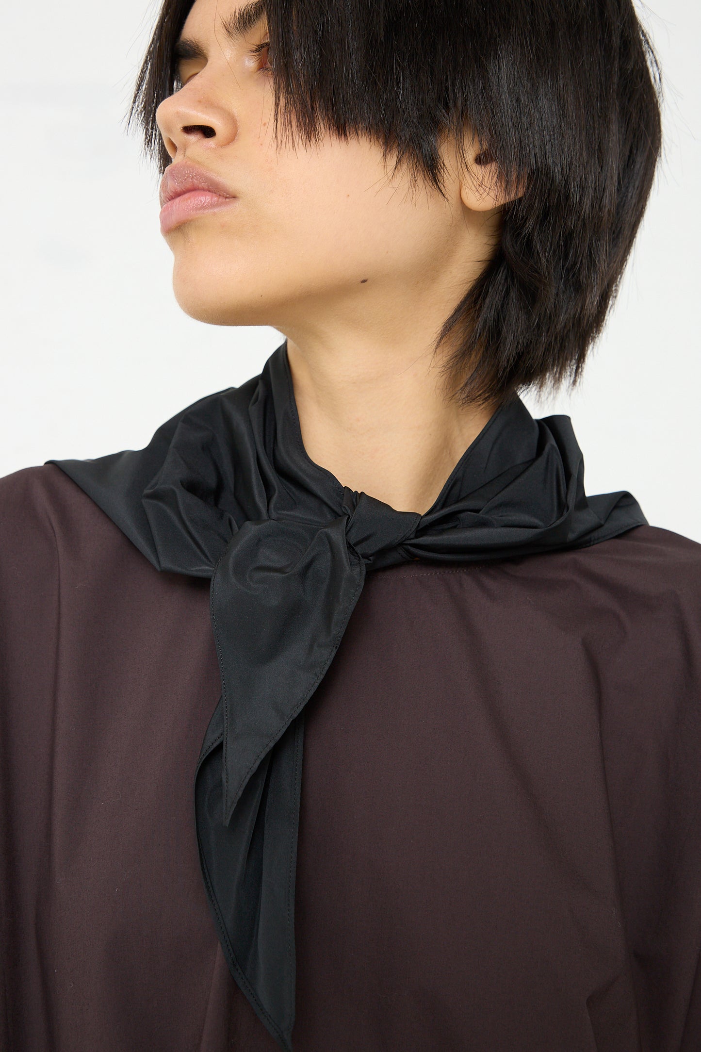A woman wearing a Sofie D'Hoore Cotton Poplin Bendol Top with black Scarf.