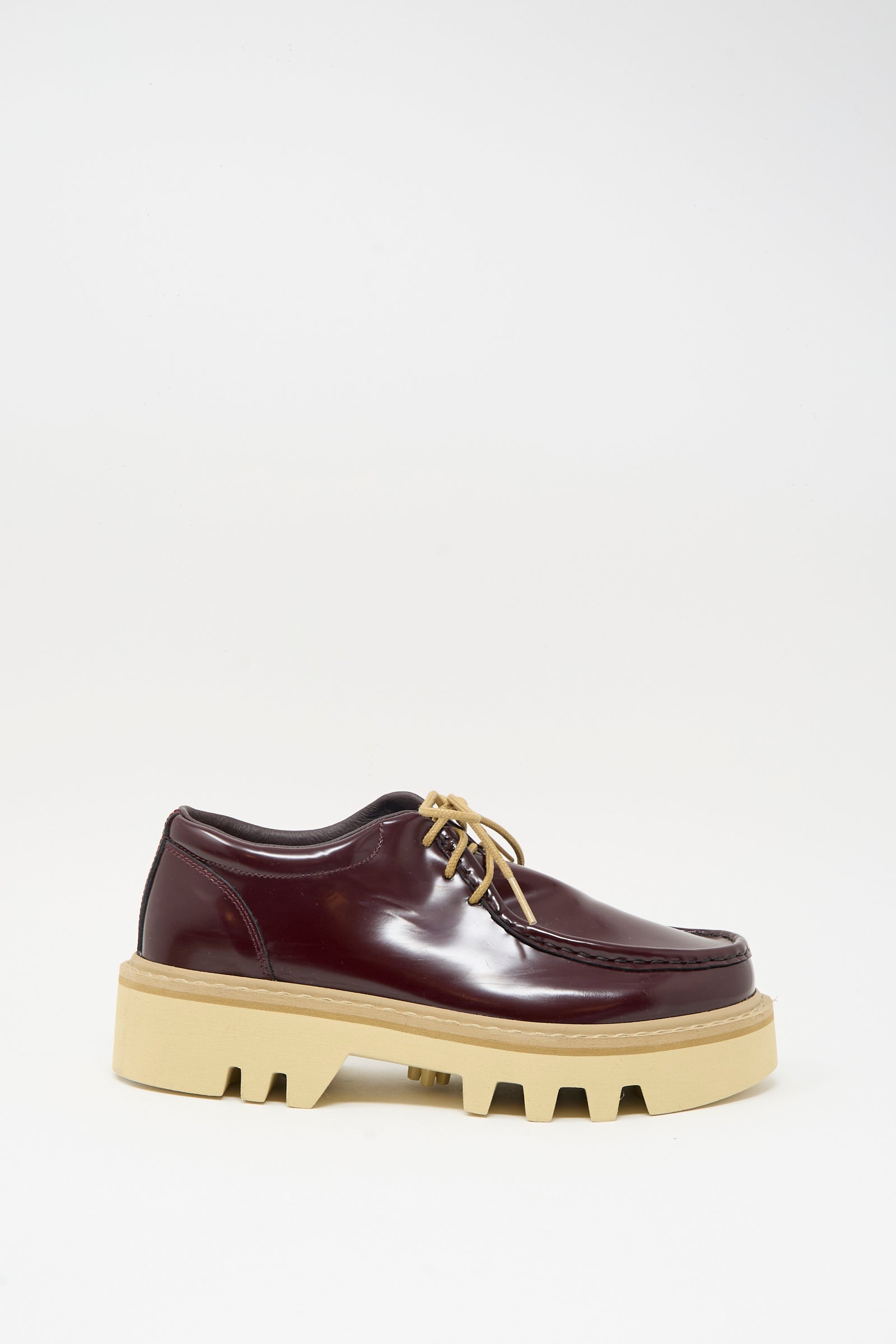 The Sofie D'Hoore Falcone Wallabee Shoe in Mahogany features tan laces and a thick, rugged beige rubber sole, showcased against a plain white background.