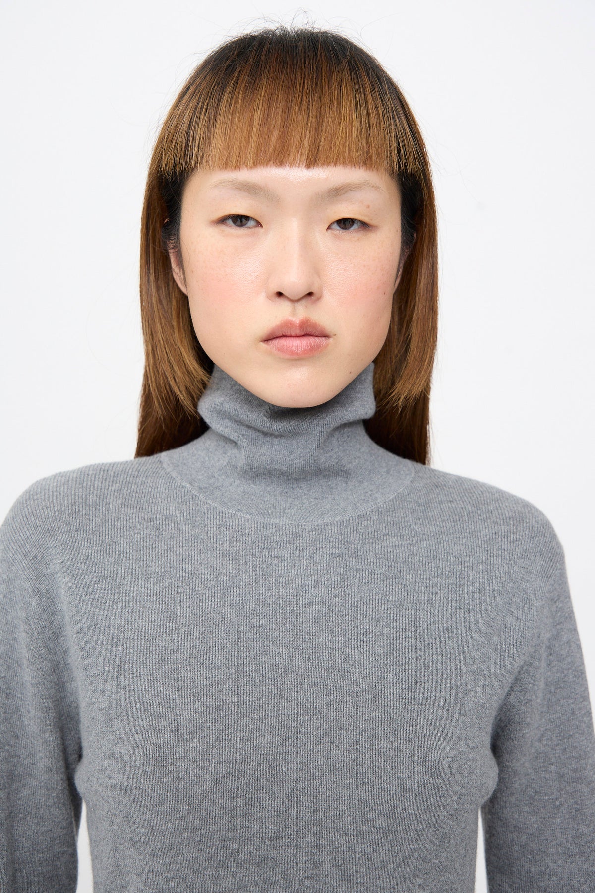 Malika Sweater in Grey Melange rib-knit turtleneck.