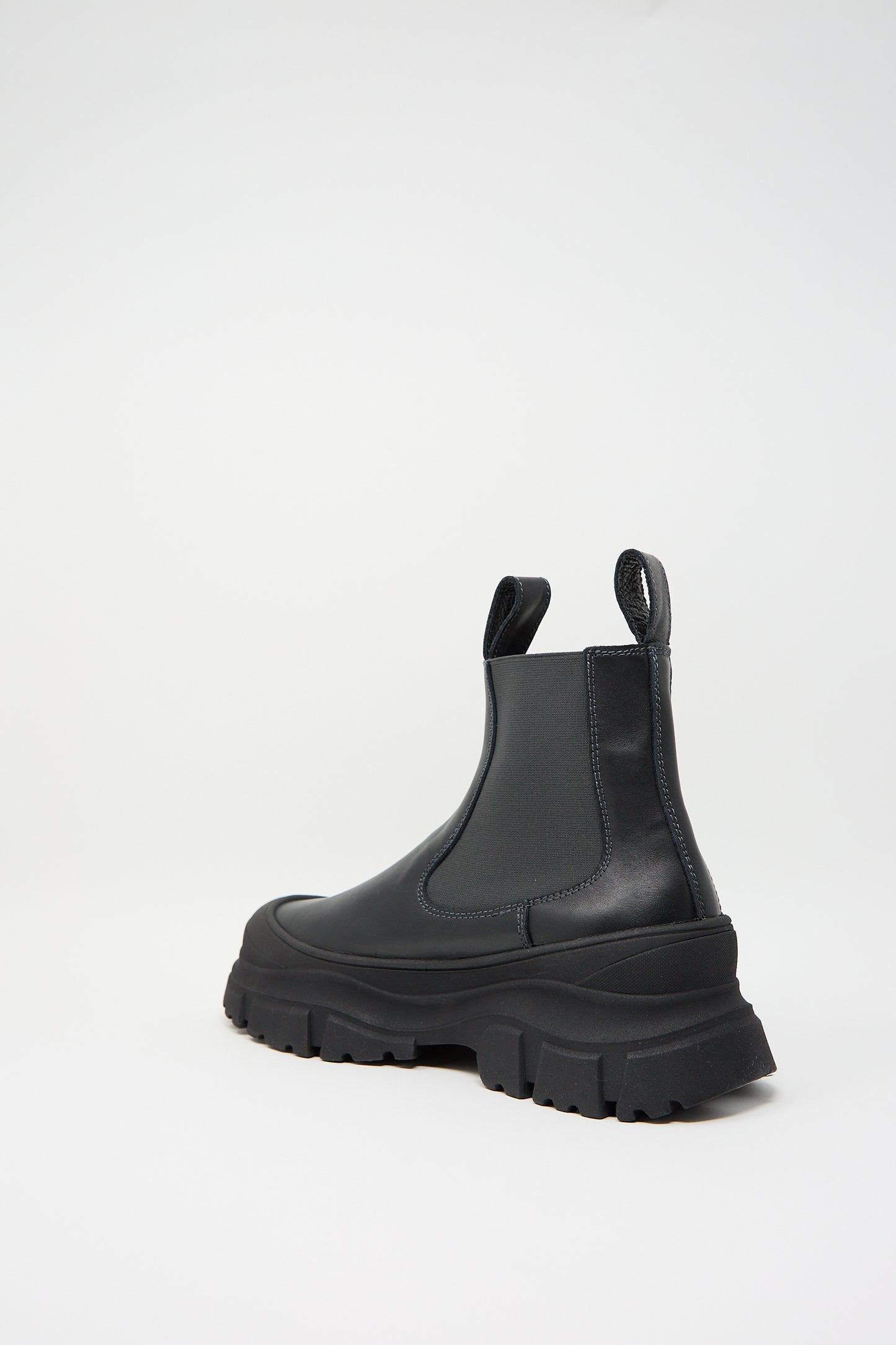 A single Nappa Leather Fabulous Boot in Black by Sofie D'Hoore, featuring a chunky Chelsea design with thick tread, elastic side panels, and a sleek rubber cap toe is showcased against a plain white background.