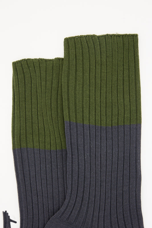 A pair of Sofie D'Hoore Ribbed Cotton Four Crew Socks in Khaki and Pebble, with a green upper portion and a navy blue lower portion, displayed against a white background.