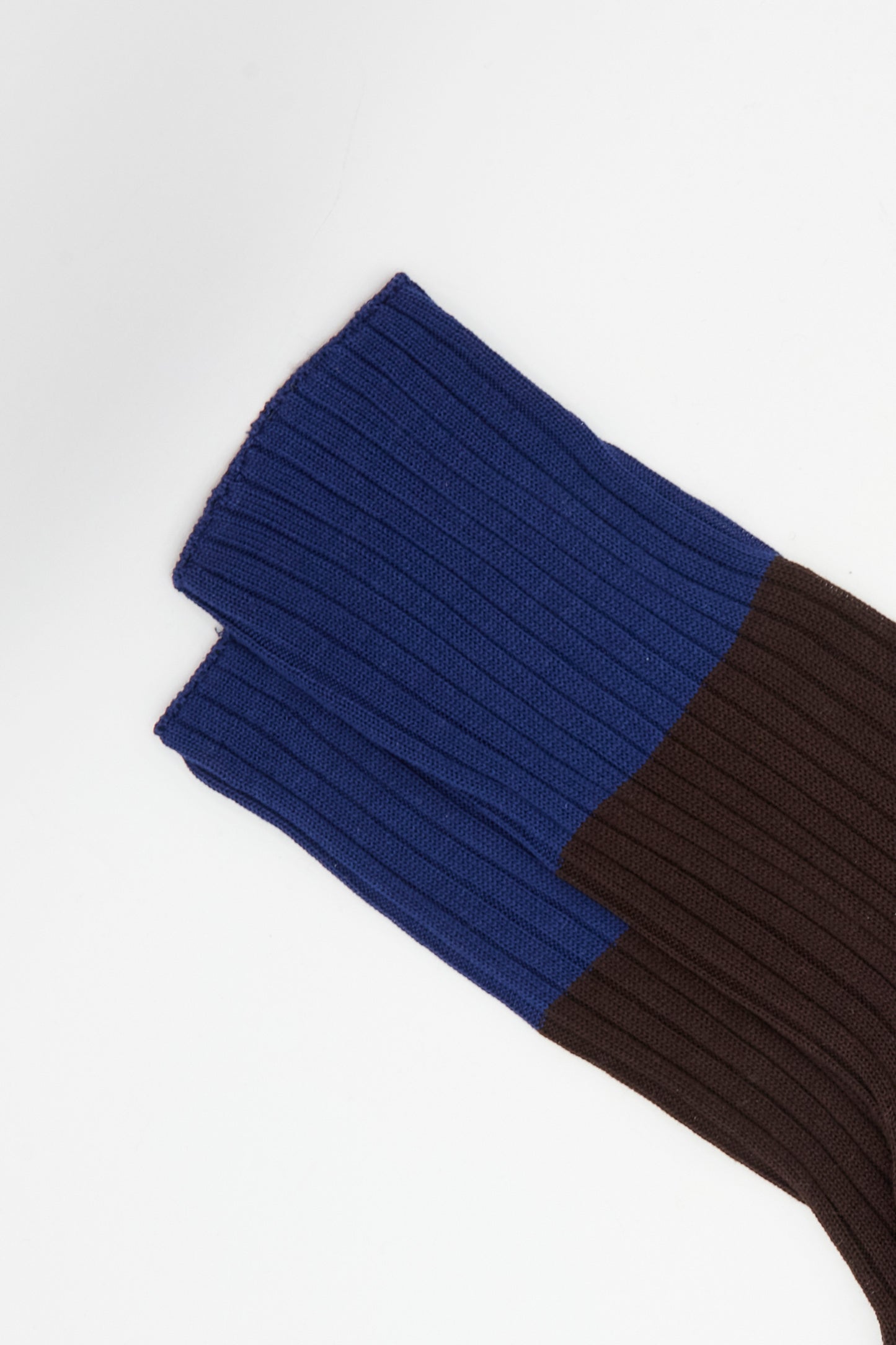 Close-up of Sofie D'Hoore's Ribbed Cotton Four Socks in Dark Blue and Cacao, laid flat on a white background, showing premium ribbed fabric.