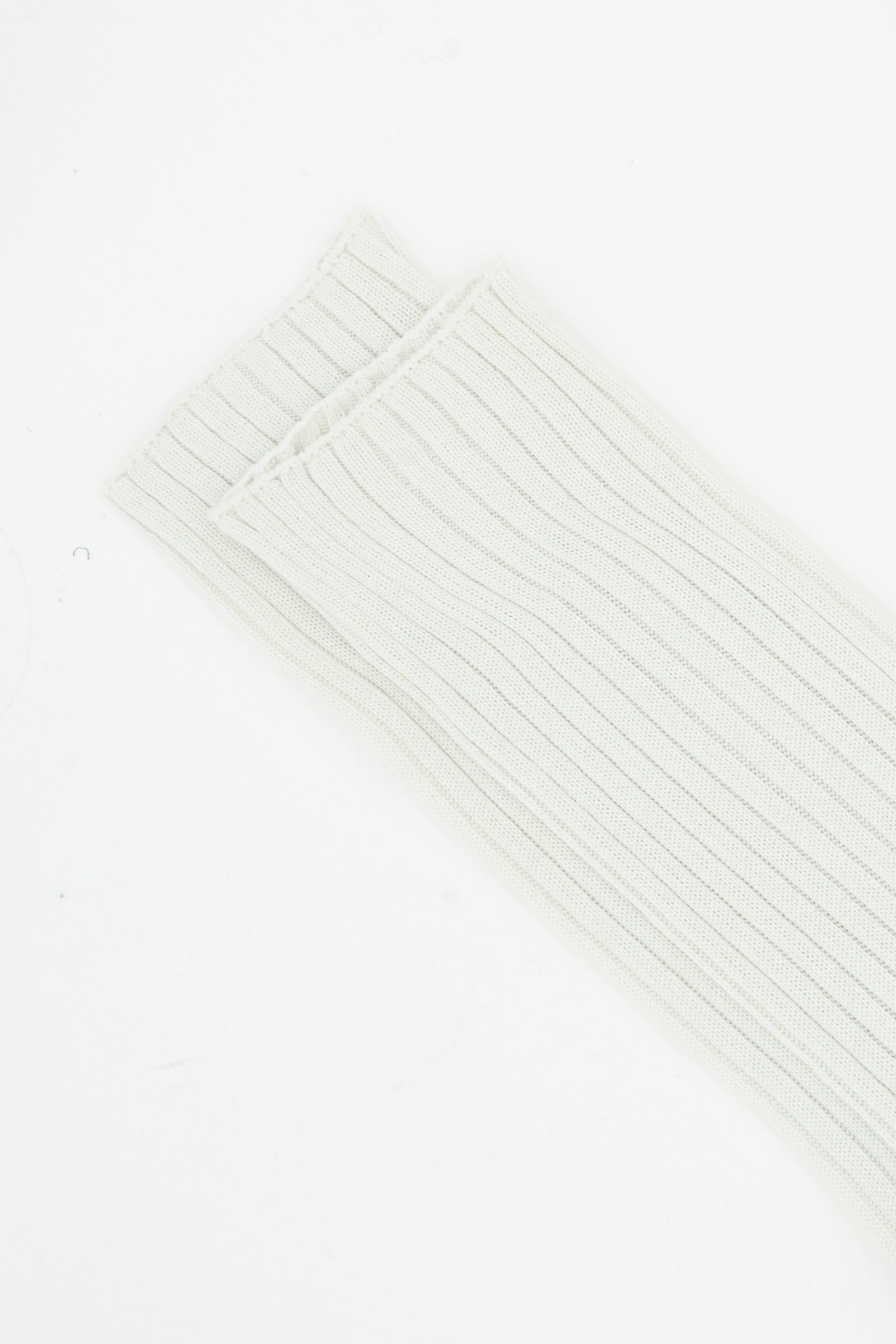 A close-up of two folded Ribbed Friday Socks in Mastic and Peanut by Sofie D'Hoore on a plain white background.