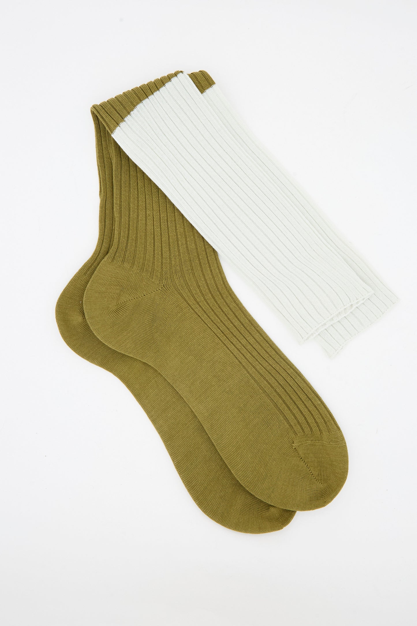 Two Sofie D'Hoore Ribbed Friday Socks in Mastic and Peanut laid flat on a white background; one is a light beige (Mastic) and the other is brown (Peanut).