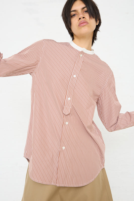 A model wearing a Sofie D'Hoore Woven Cotton Boyd Shirt in Brick Stripe and Ivory.