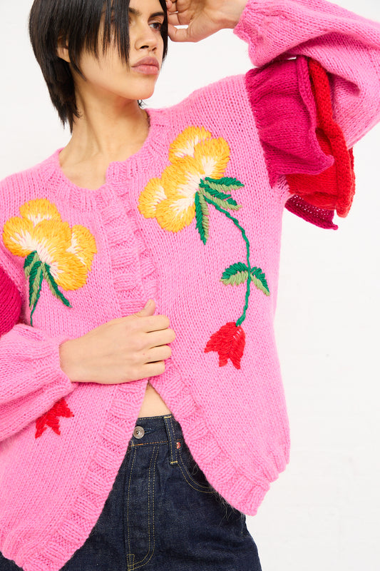 Woman in a Sofio Gongli pink mohair wool blend cardigan with floral embroidery, posing against a white background.