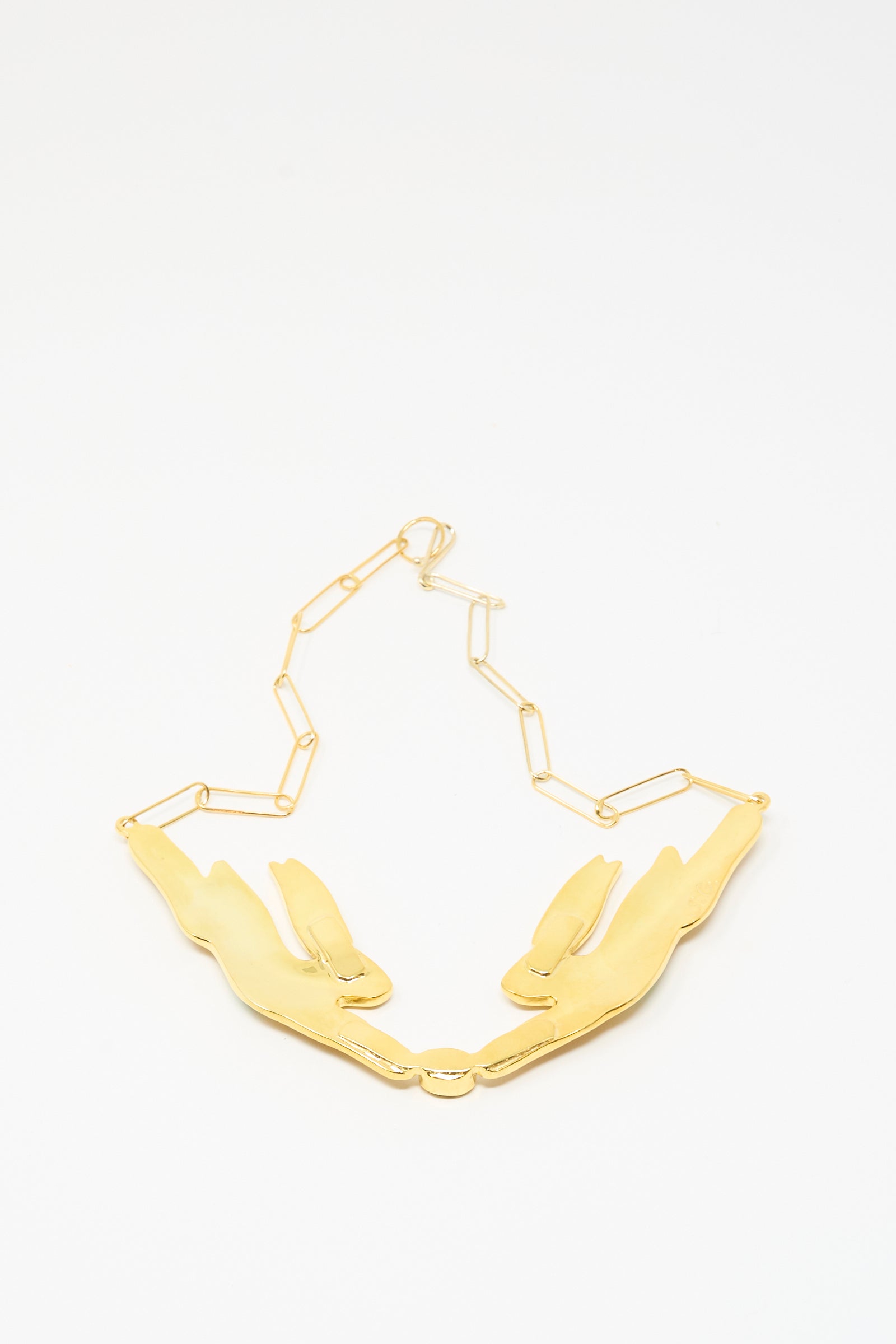 The Hare Necklace by Sofio Gongli features two 14K gold plated reclining rabbit pendants on a geometric chain, reminiscent of an enamel hare design, and is displayed on a white background.