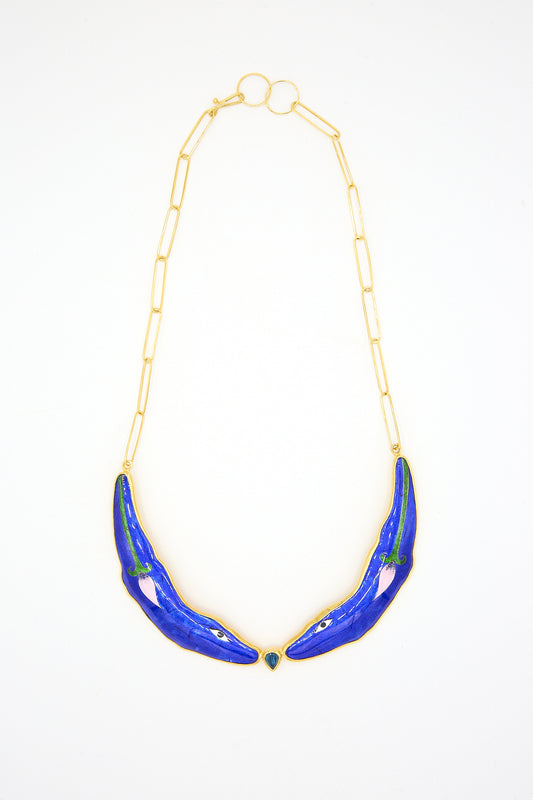 A Necklace in Blue Animal by Sofio Gongli, with blue enamel detailing utilizing the Byzantine technique and a small green gem at the center, displayed against a white background.